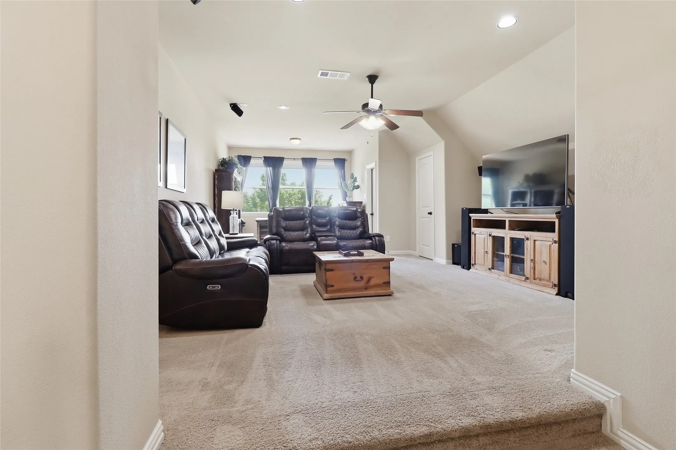 Upstairs Spacious carpeted room featuring a ceiling fan, recessed lighting, and an entertainment console