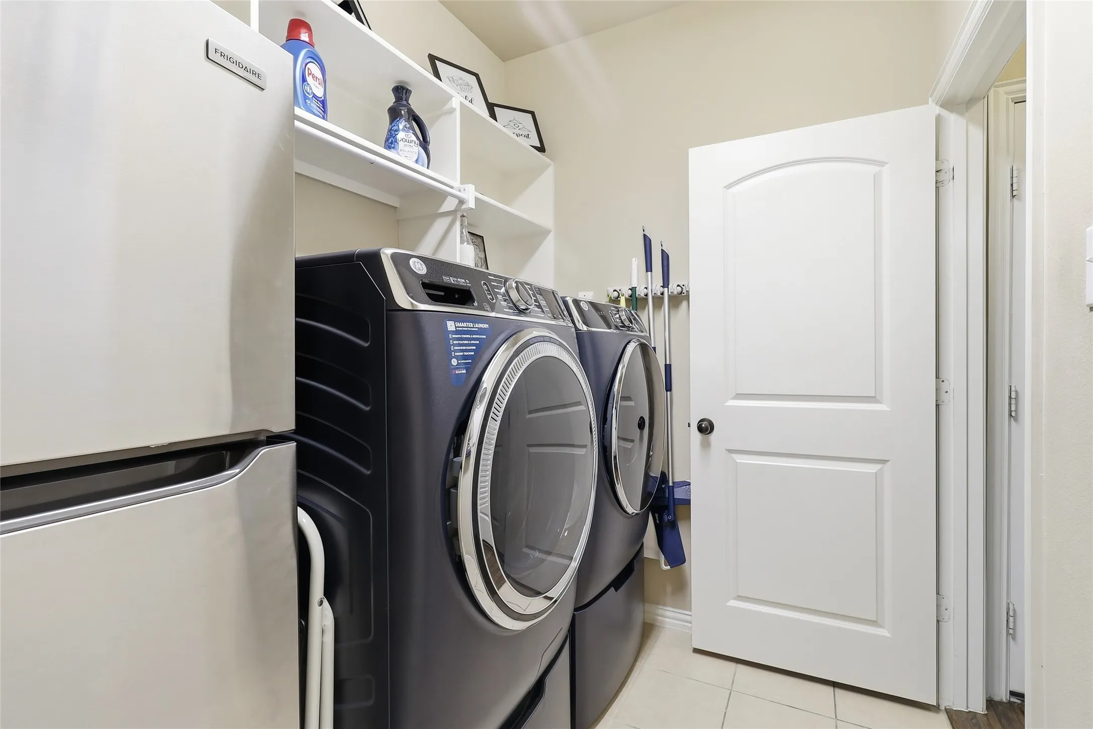 Laundry room featuring light-colored walls and tiled flooring