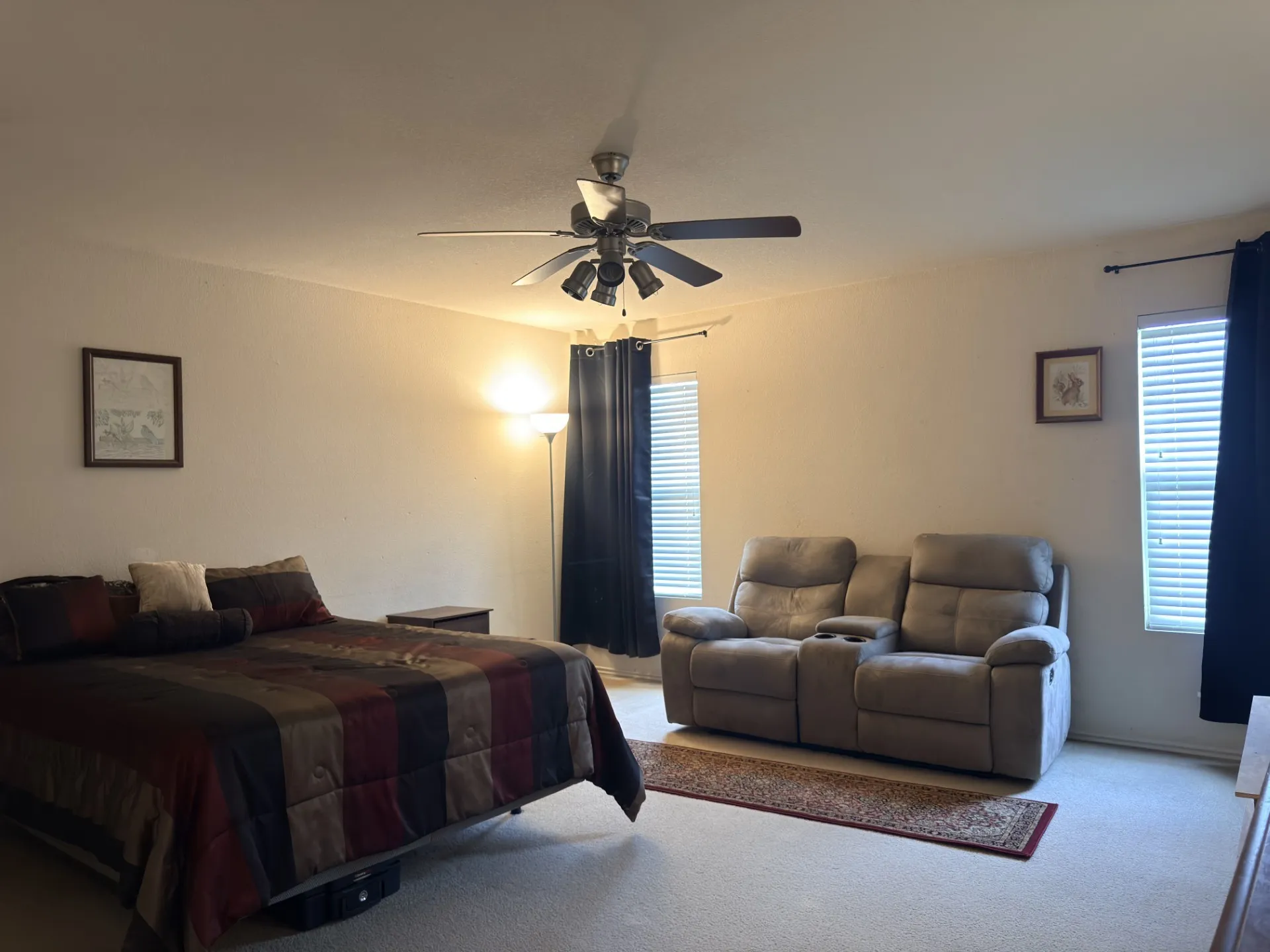 Primary bedroom with sitting area.