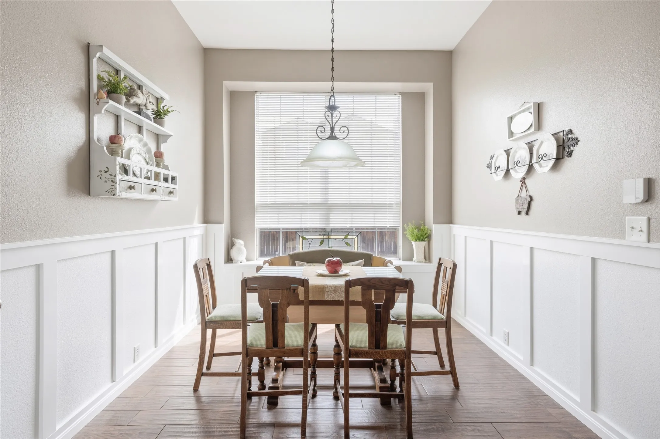 Wood-finish flooring throughout, complemented by crisp white board and batten wainscoting