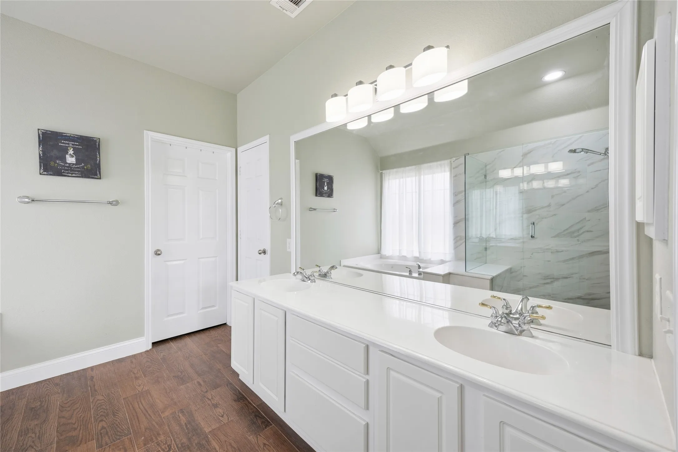 Double vanity with white cabinetry and integrated sinks