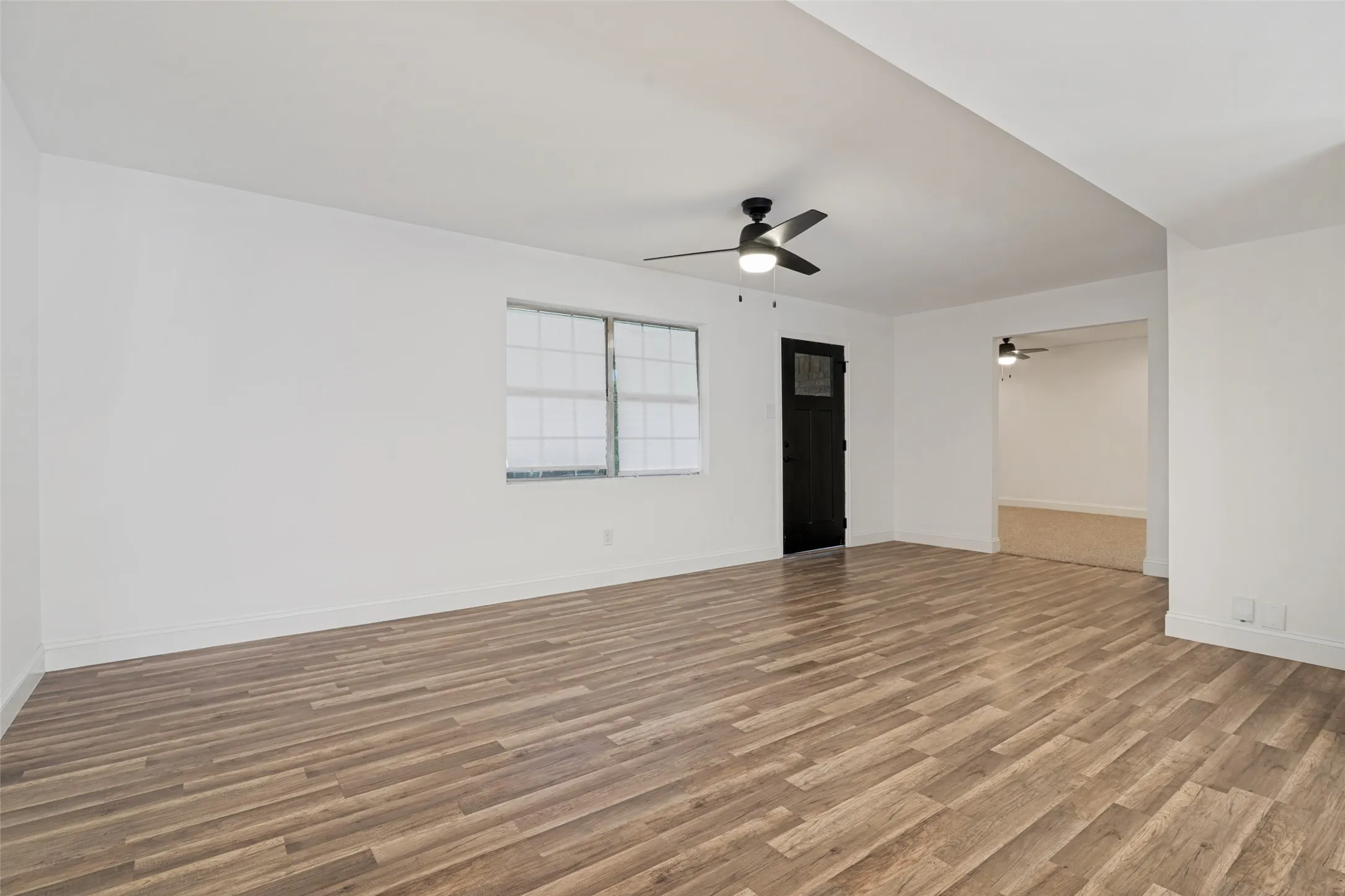 Living Room looking at entry door from dining room