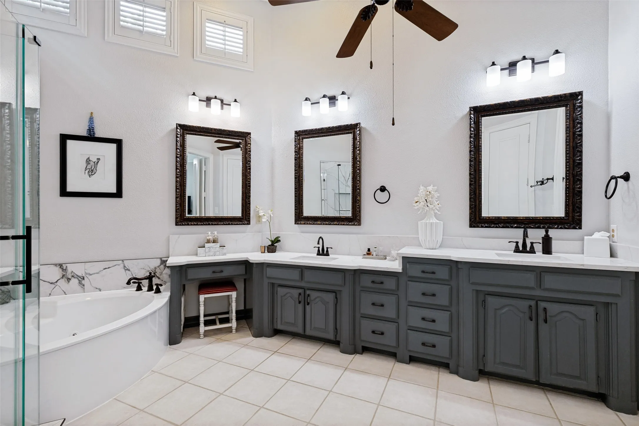 The remodeled Primary Bath is spa-like with a frameless glass door and tile covered shower & romantic corner tub. Stylish updated lighting, mirrors. Light filled with high soaring ceilings.The remodeled Primary Bath is spa-like with a frameless glass door and tile covered shower & romantic corner tub. Stylish updated lighting, mirrors. See the walk-in closet with great storage & built in chest of drawers.See the walk-in closet with great storage & built in chest of drawers.