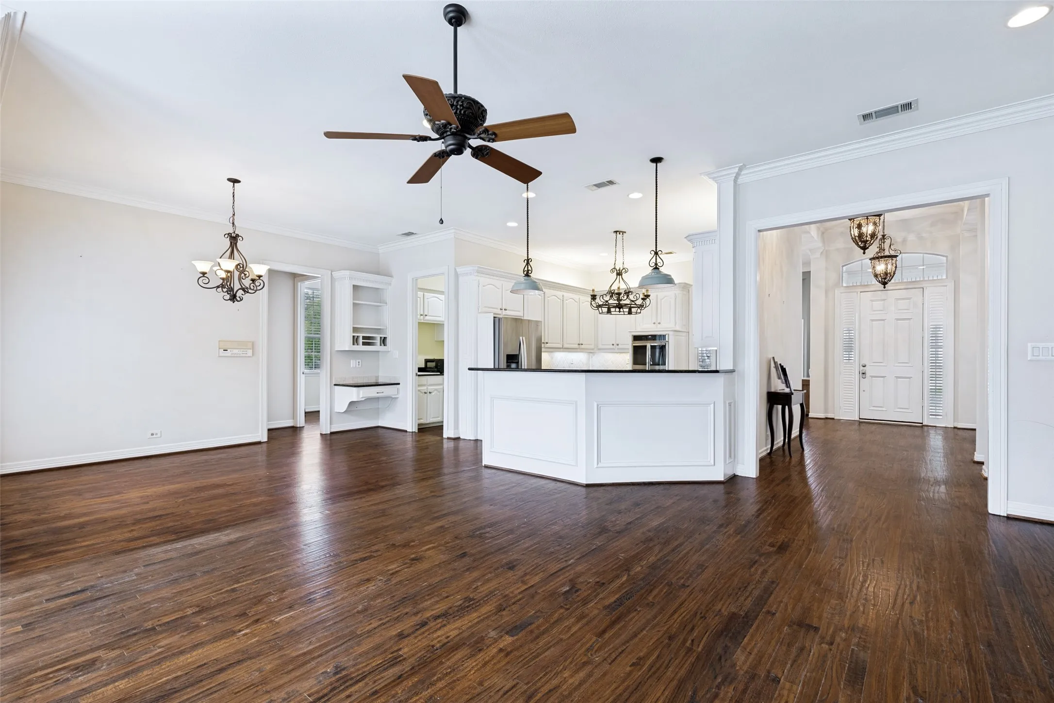 View from the Family room to the Foyer, kitchen, Casual dining. On the left- See the hall to a 3rd Bedroom & Full Bath.
