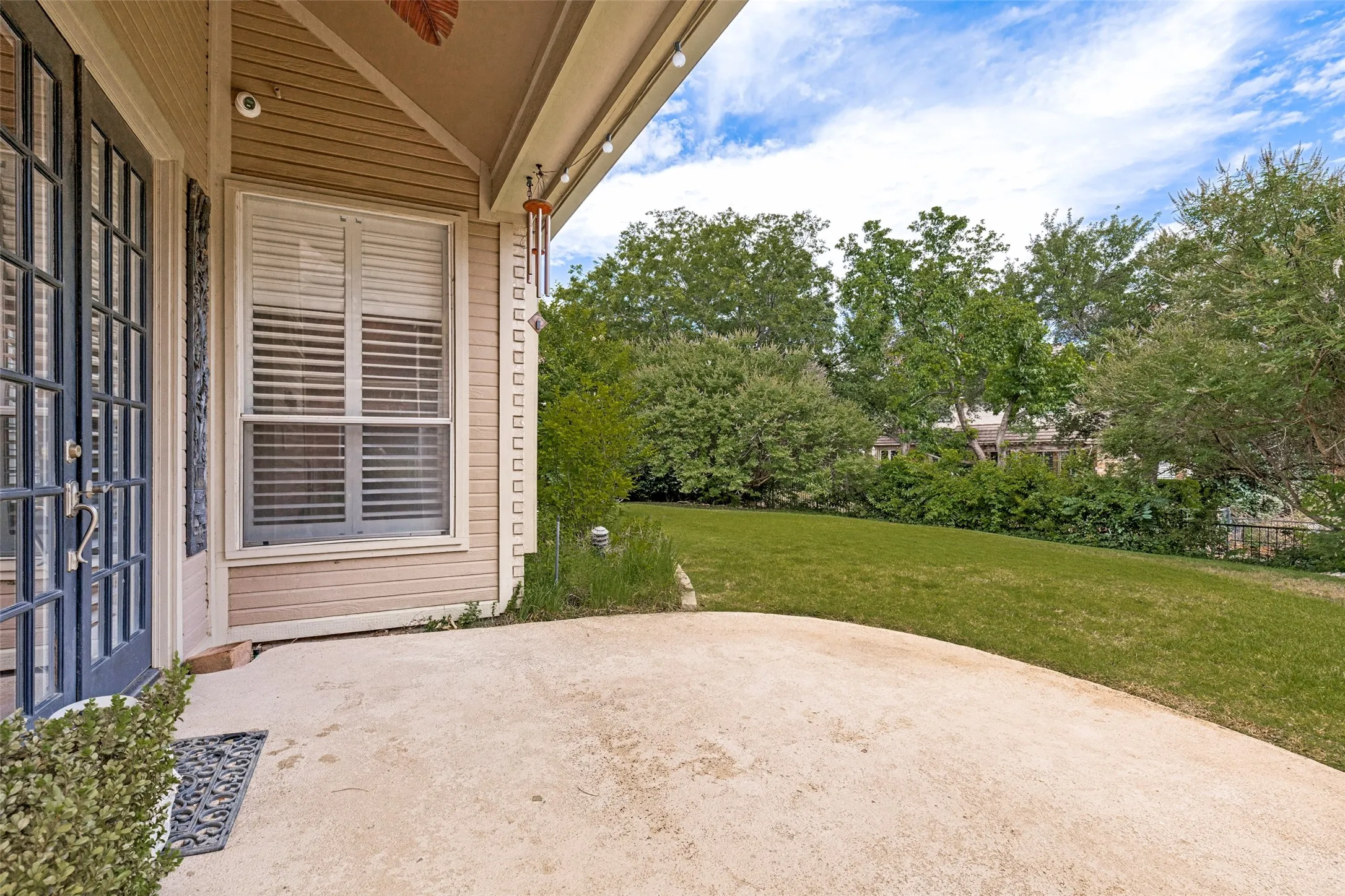 Covered and extended patio. A private greenbelt backyard with lush landscape and mature trees.