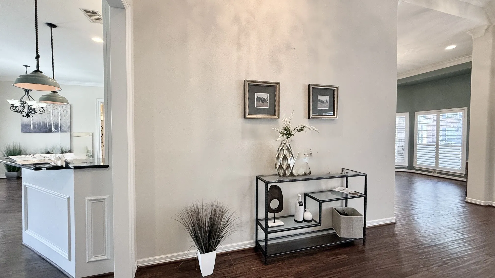 The inviting foyer entrance flows seamlessly into the formal living and dining areas, kitchen, and family room, all highlighted by hardwood floors, elegant light fixtures, and exquisite millwork.