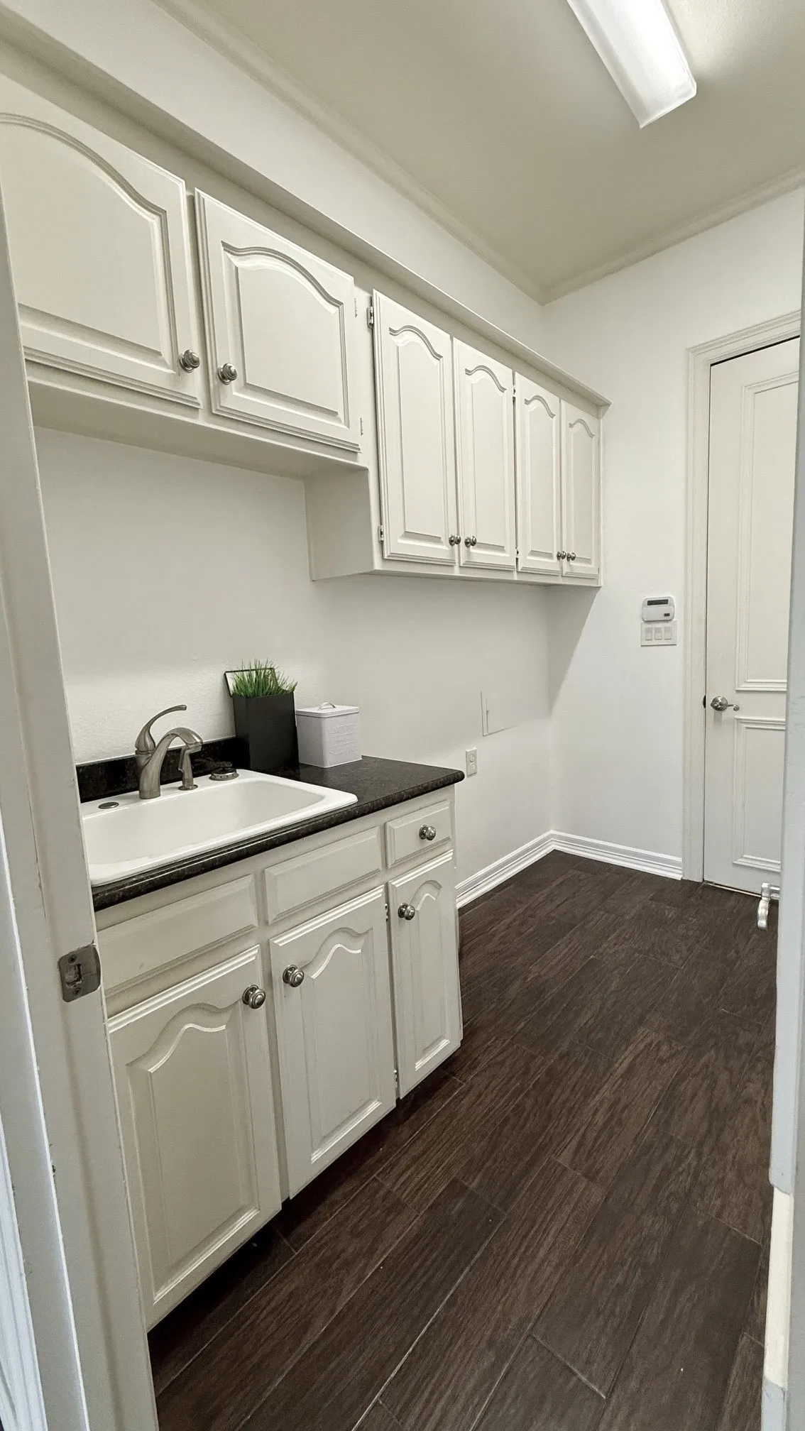Full laundry with sink, upper-lower cabinets- gas/eclectric dryer options.