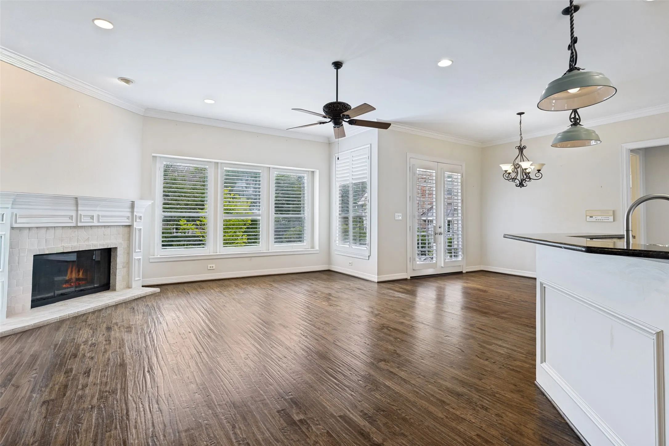 Lovely mantled corner fireplace, high ceilings with a wall of windows, hardwood floors. Double doors off the casual dining space lead to the covered patio with lush landscaping - backing to a private greenbelt.