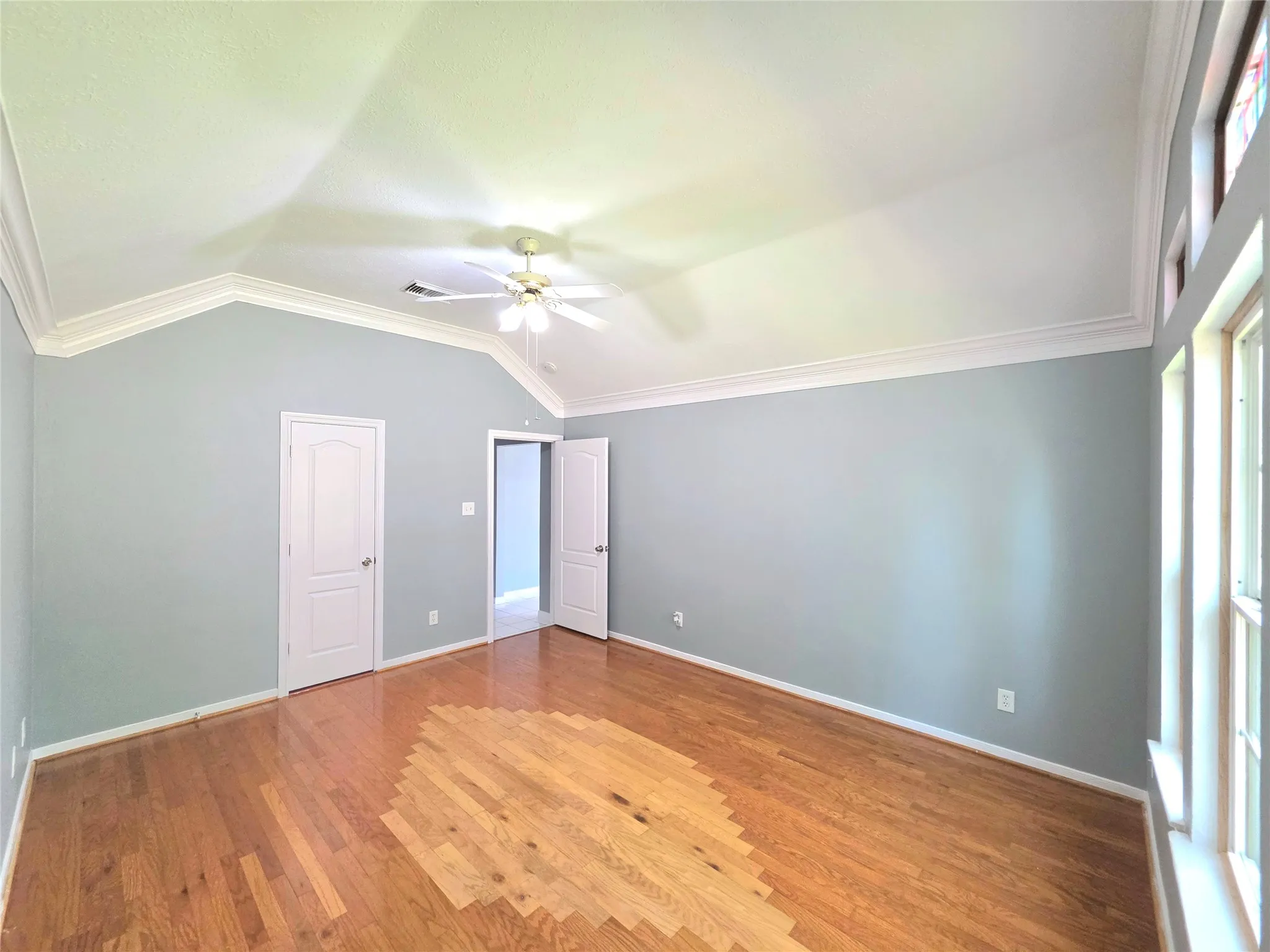 Vaulted ceiling featuring crown molding