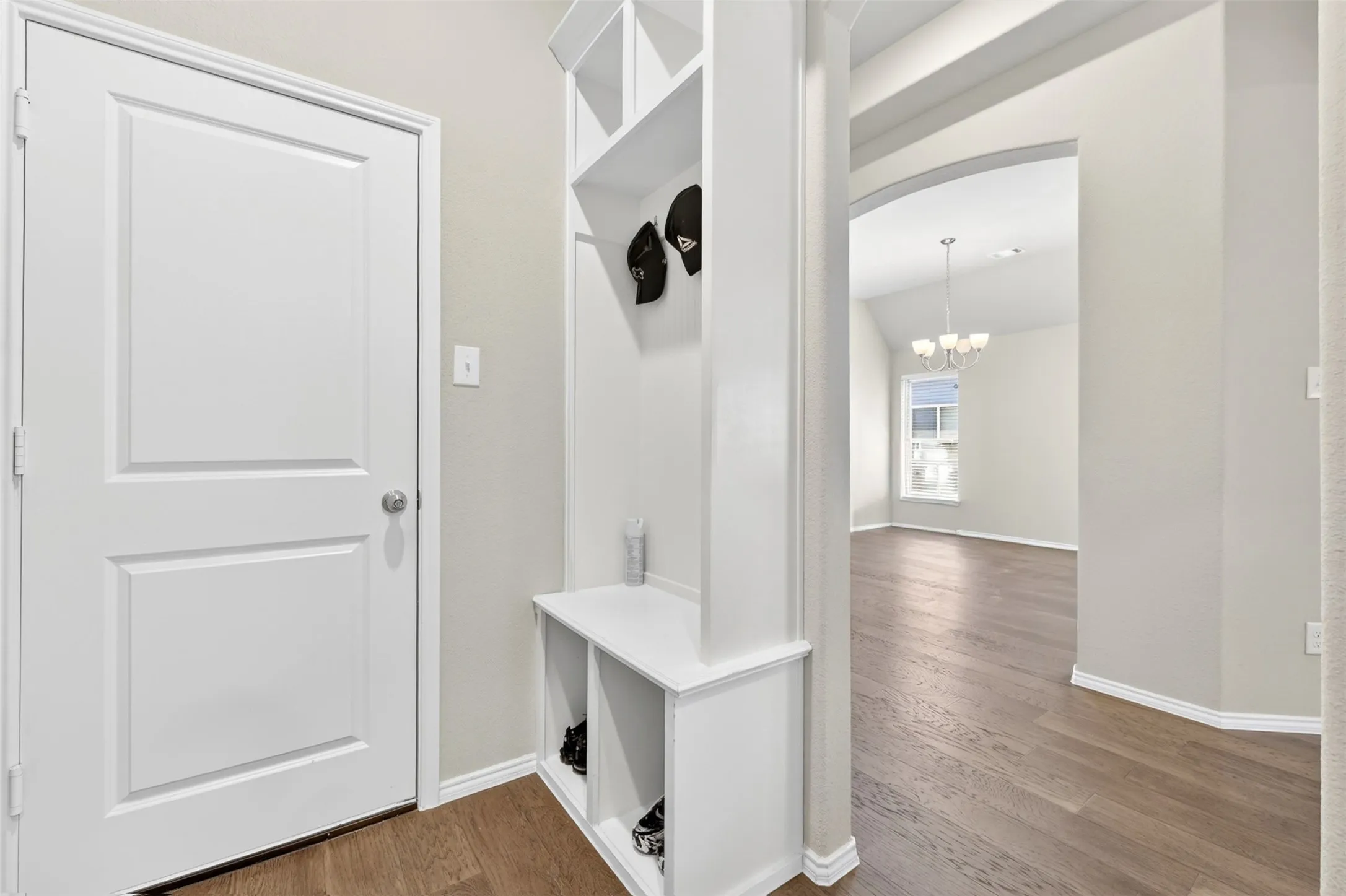 Entryway mudroom bench with integrated shelving and coat hooks