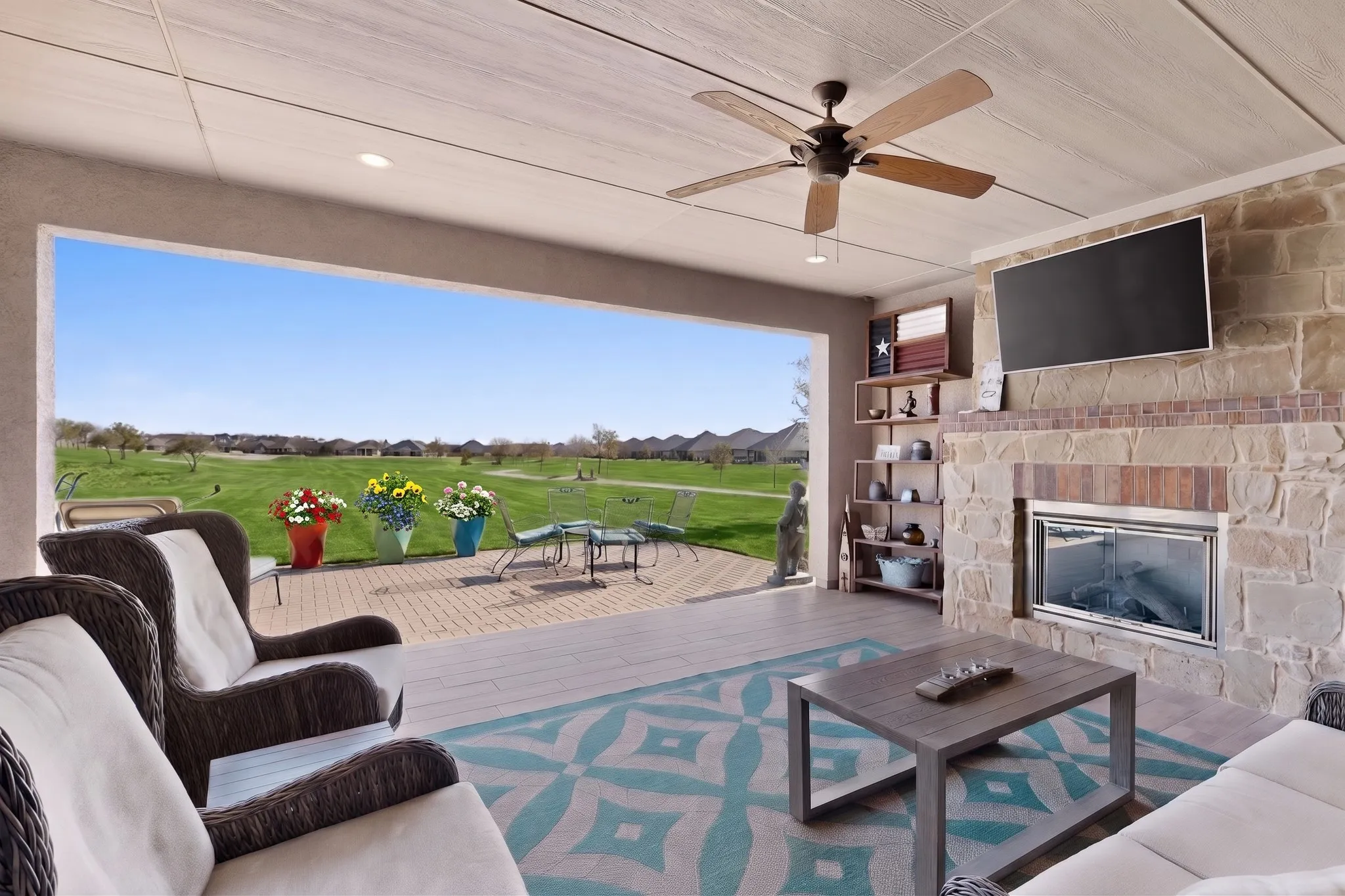 Extended covered porch with gas fireplace.