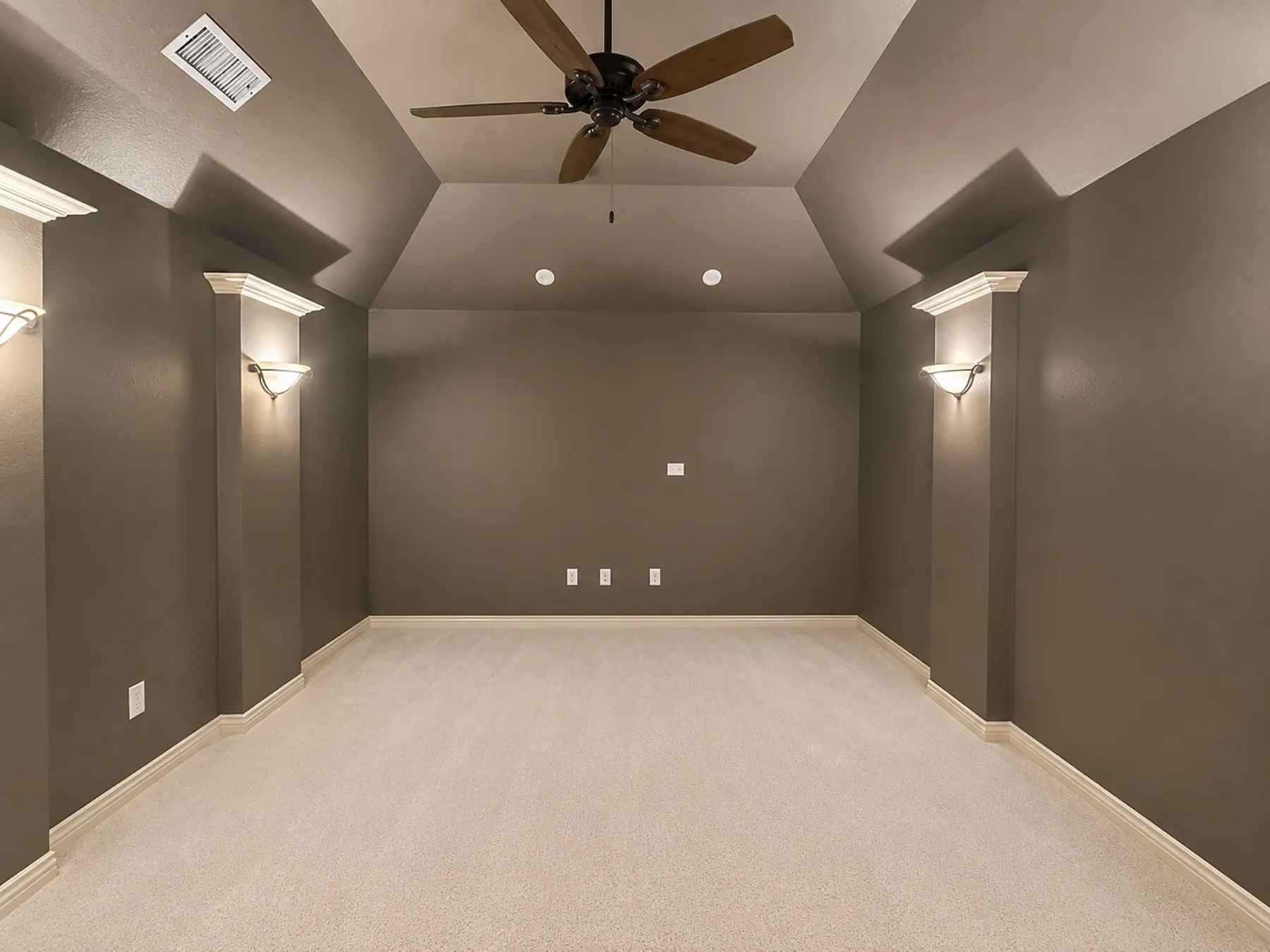 Spacious room featuring vaulted ceilings and recessed lighting