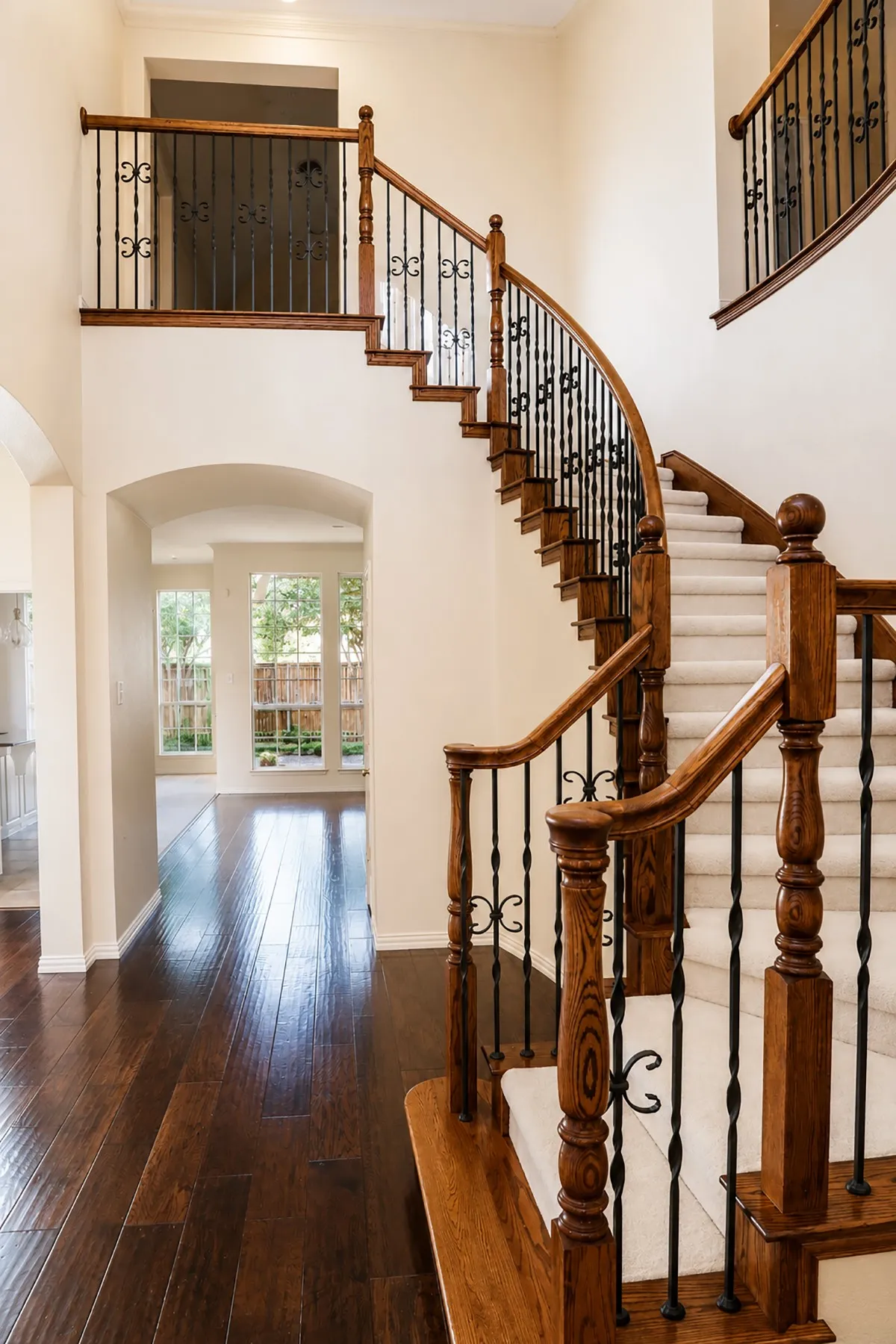 Gorgeous curved stairway frames opening to the family room, kitchen, and breakfast room.