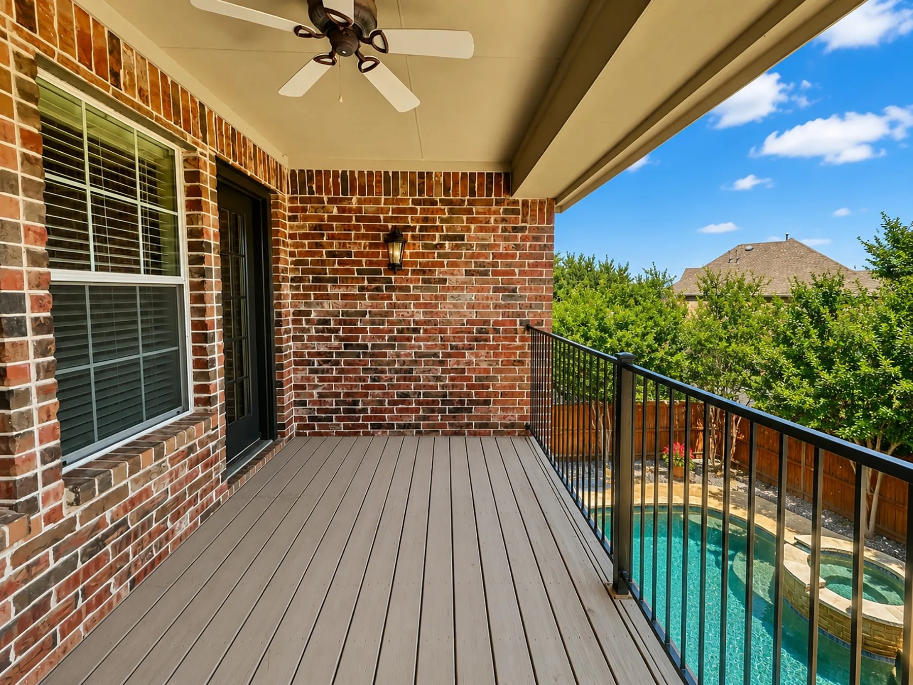 Private balcony off the game room overlooks the backyard oasis, offering peaceful views of the pool.