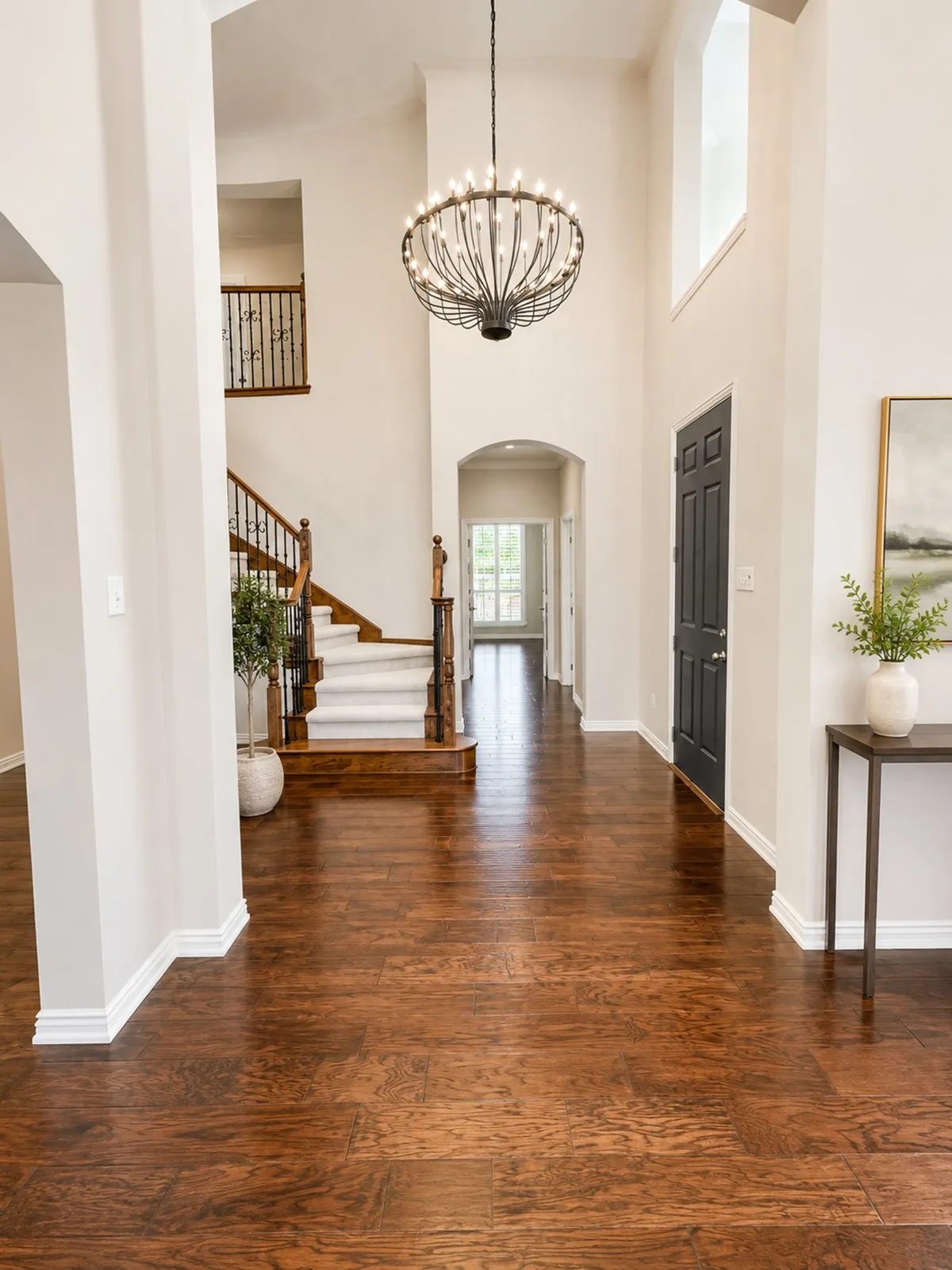 Entryway view from formal living area. Double doors open into flexible room used as a home office, or 5th bedroom. Full bath and dedicated laundry room are adjacent.