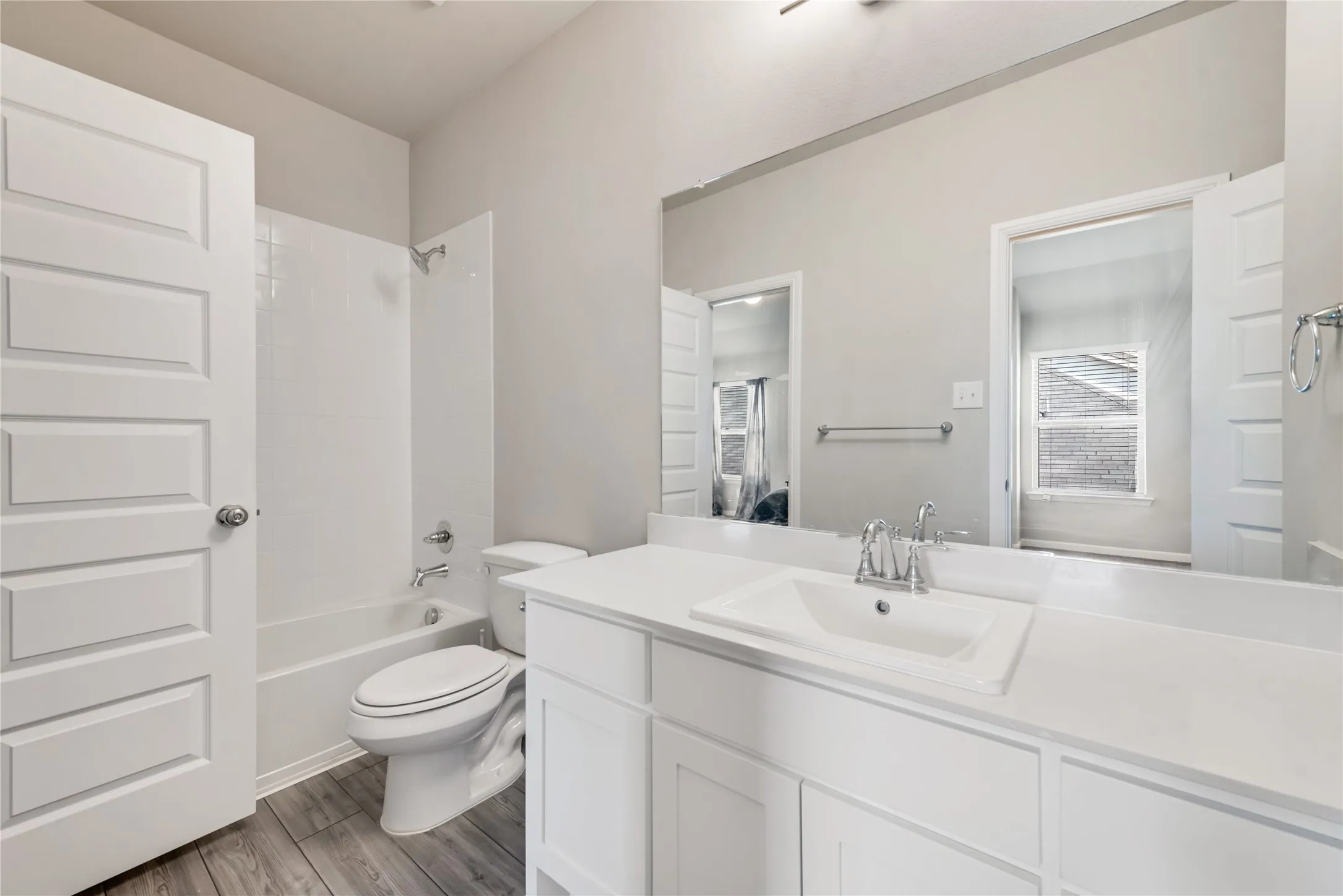Full bath featuring toilet, wood finished floors, vanity, and shower / washtub combination