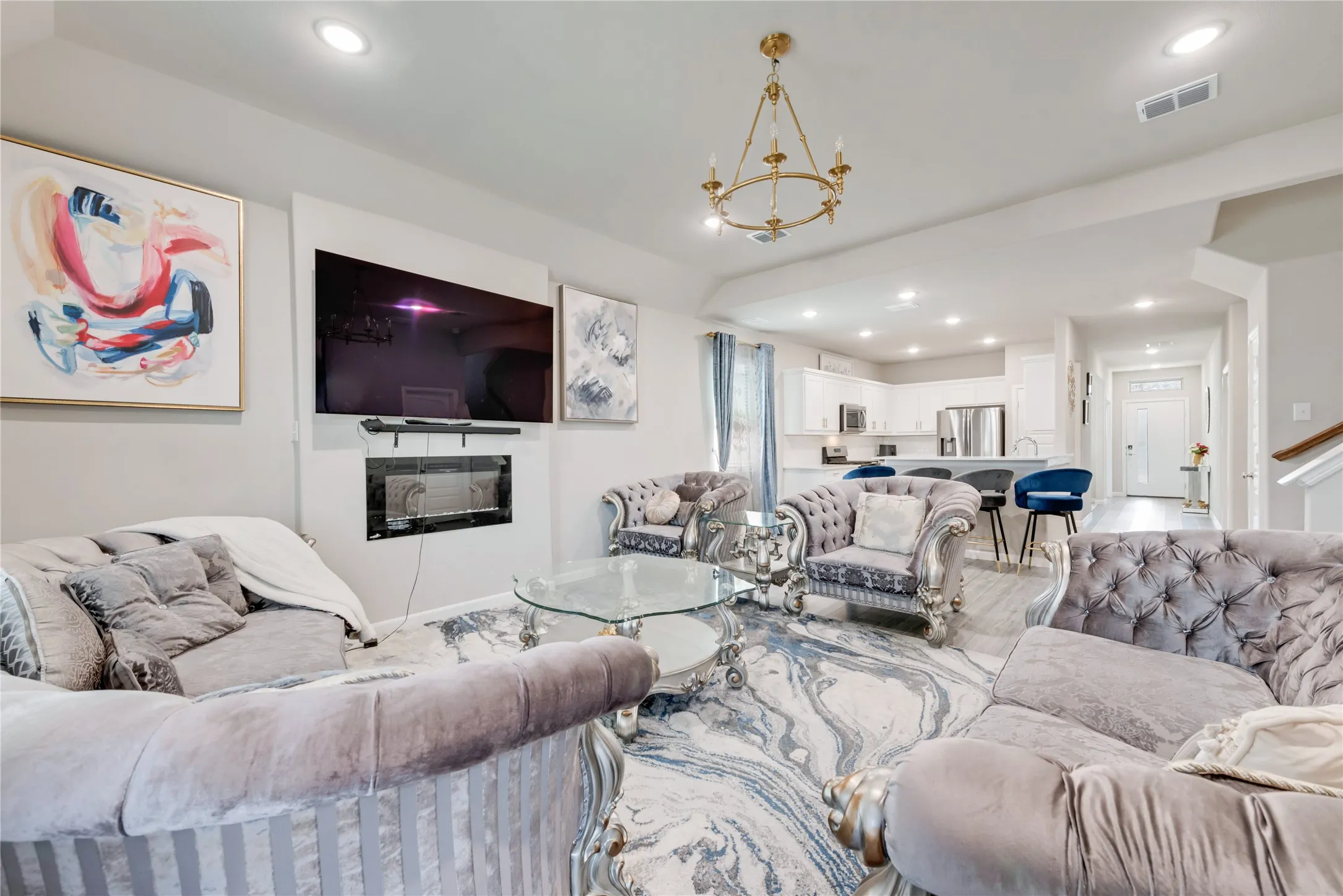 Living area with an inviting chandelier, visible vents, and recessed lighting