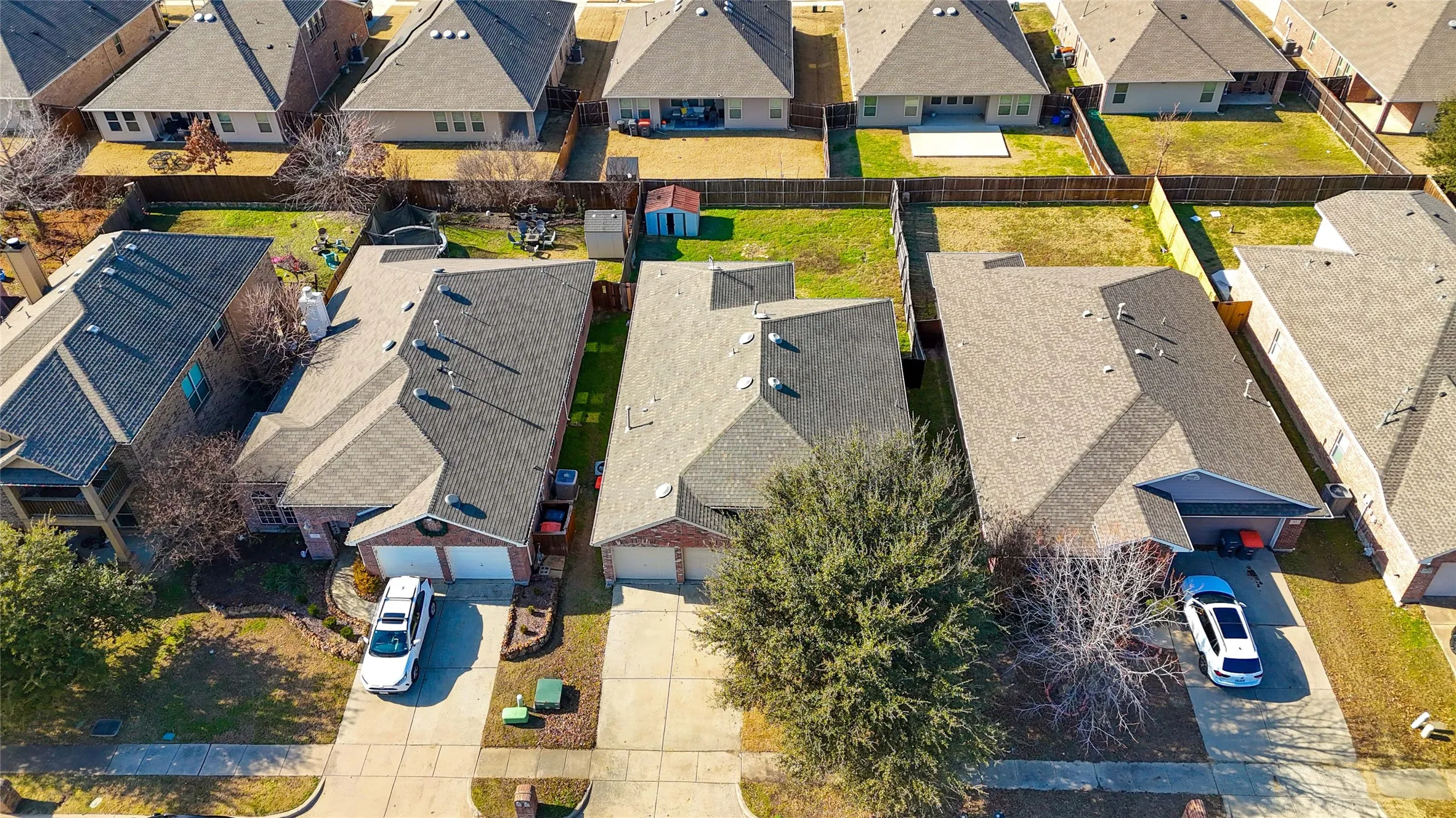 Aerial perspective showcasing residential properties with fenced backyards