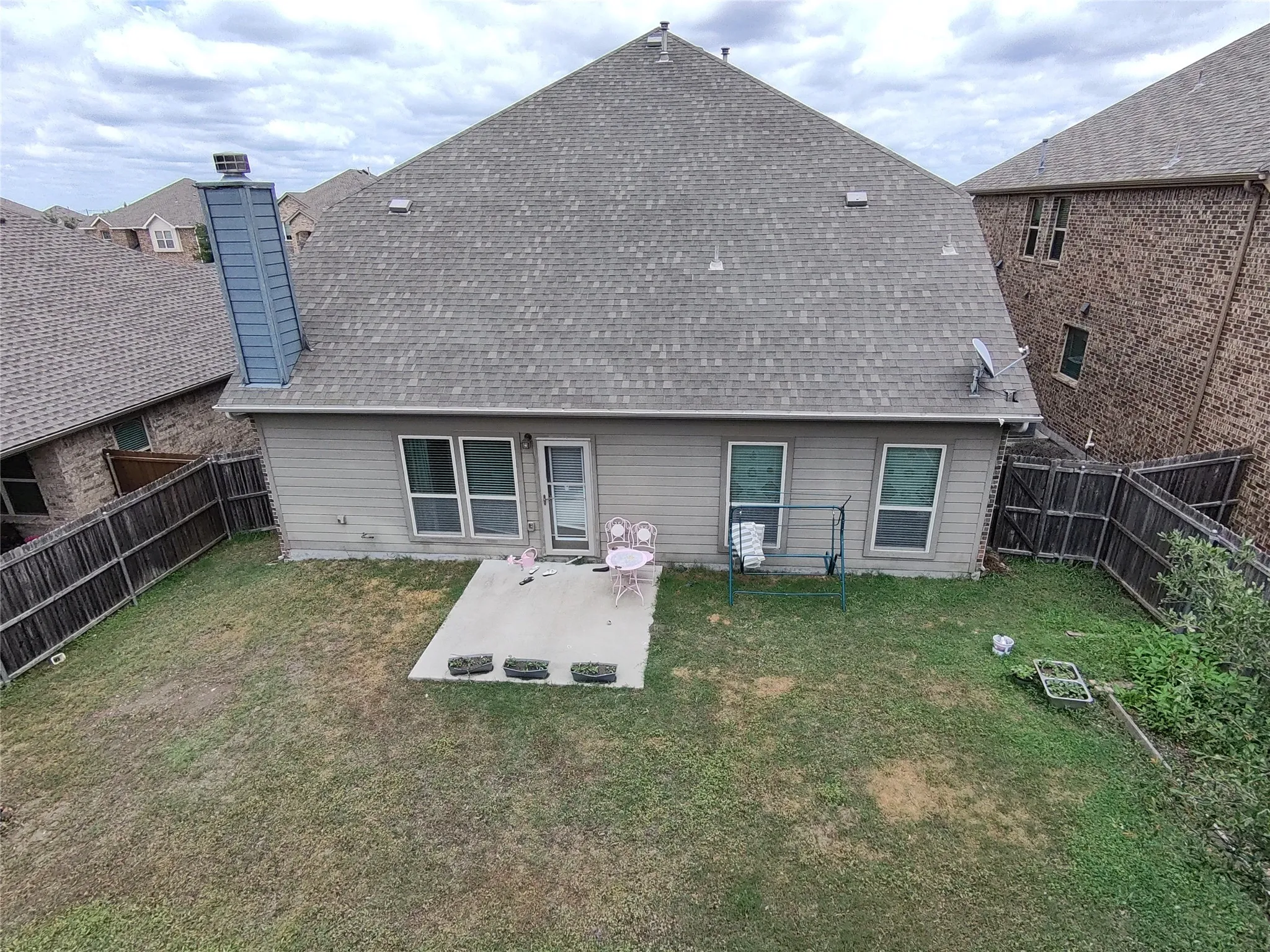 Rear exterior of a residence featuring a concrete patio