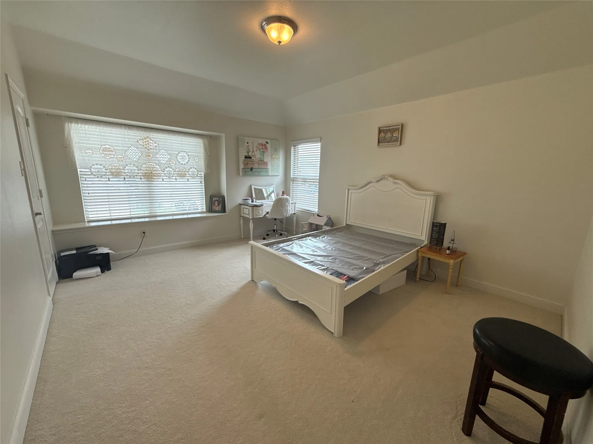 Carpeted room with a tray ceiling and a built-in window seat