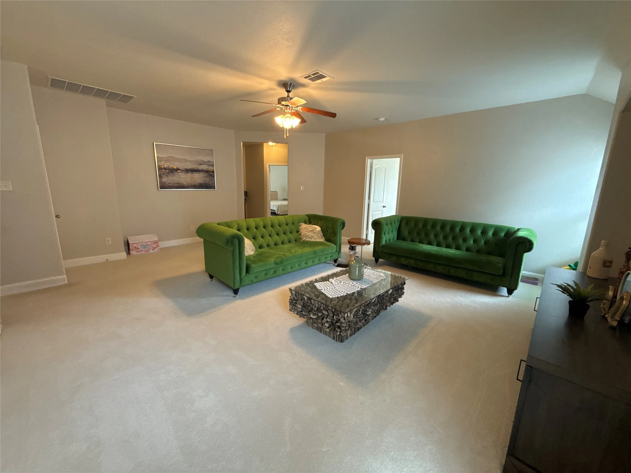 Spacious room featuring light-toned carpeting and neutral wall tones