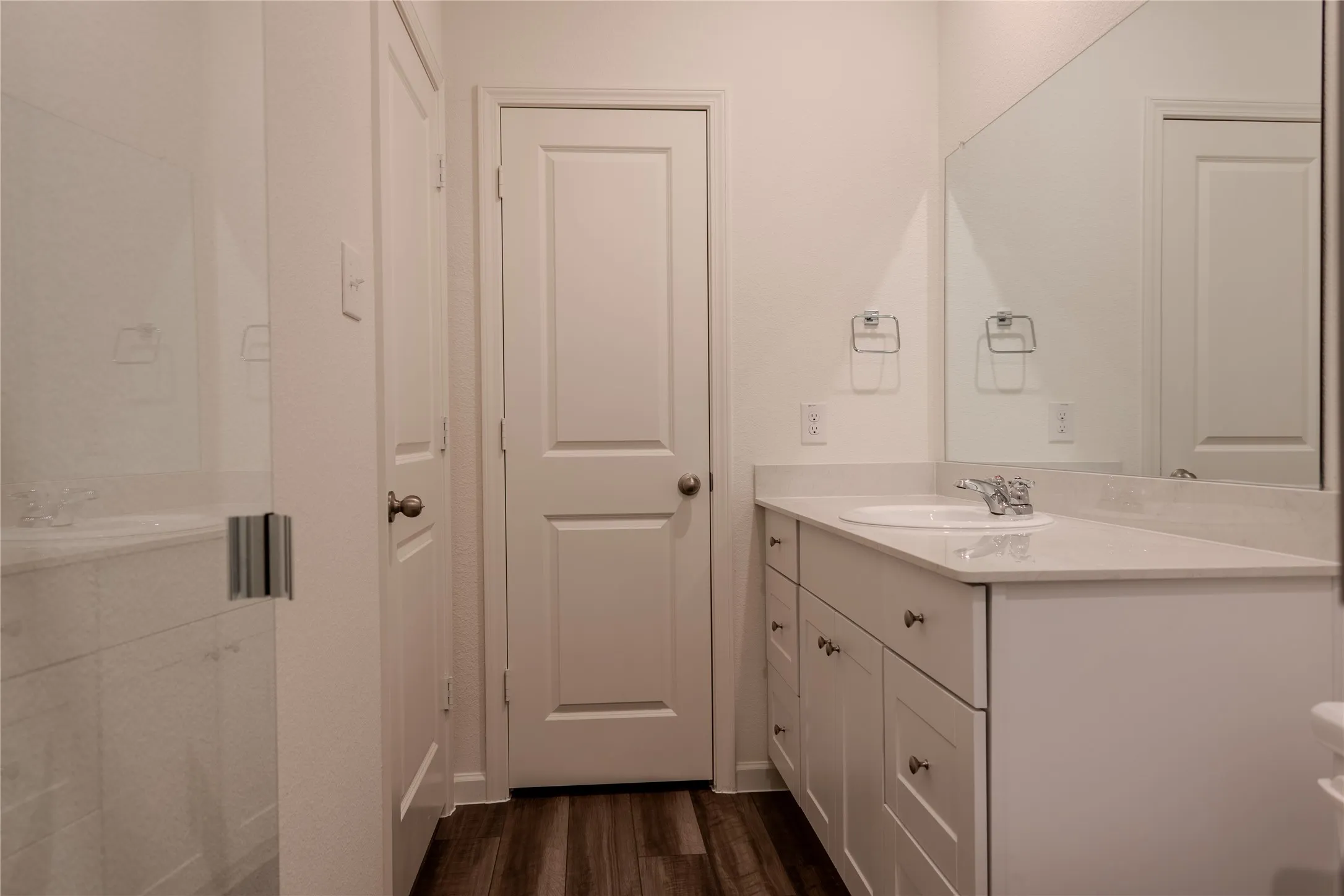 Bathroom featuring hardwood / wood-style flooring and vanity