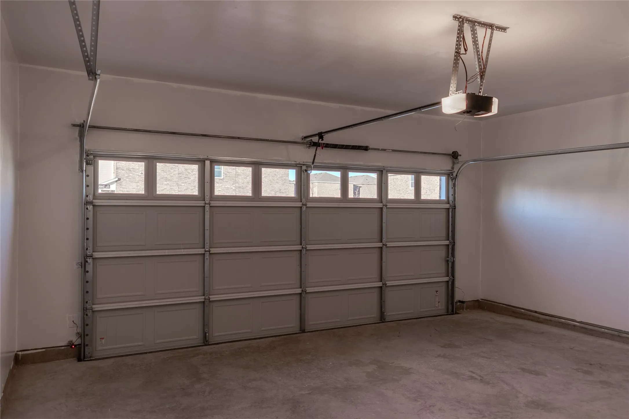 Garage featuring a garage door opener