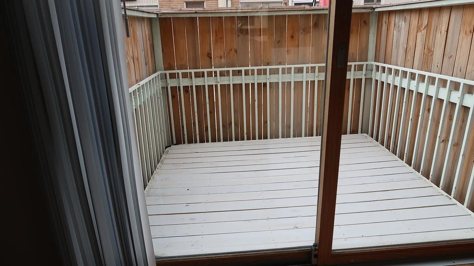 Exterior wood deck with painted white wood flooring