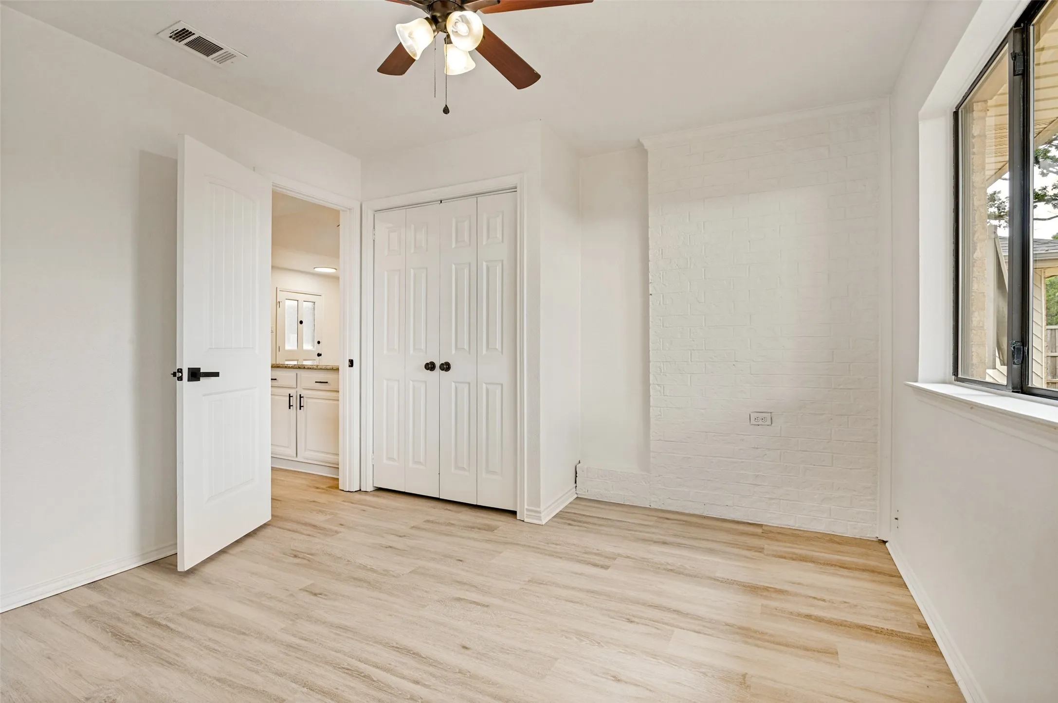 Light wood-finish flooring complements the neutral wall tones