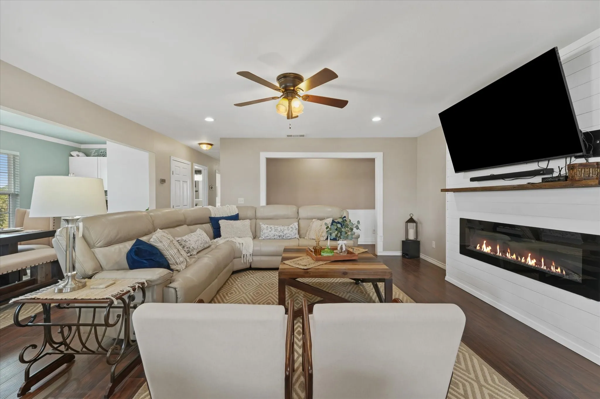 Contemporary linear fireplace with shiplap surround and wood mantel
