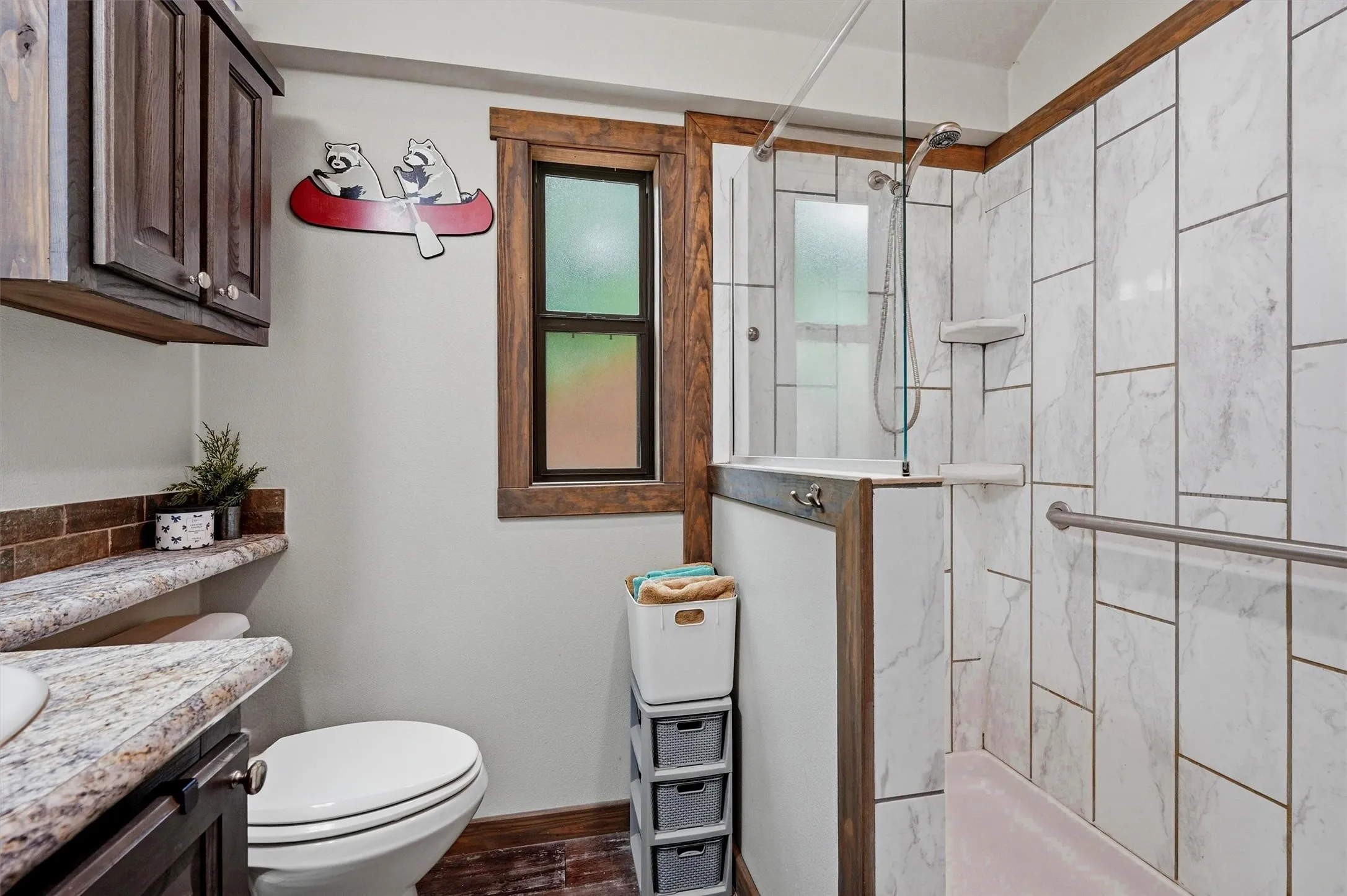 Bathroom featuring a walk-in shower with white tiled walls and glass enclosure