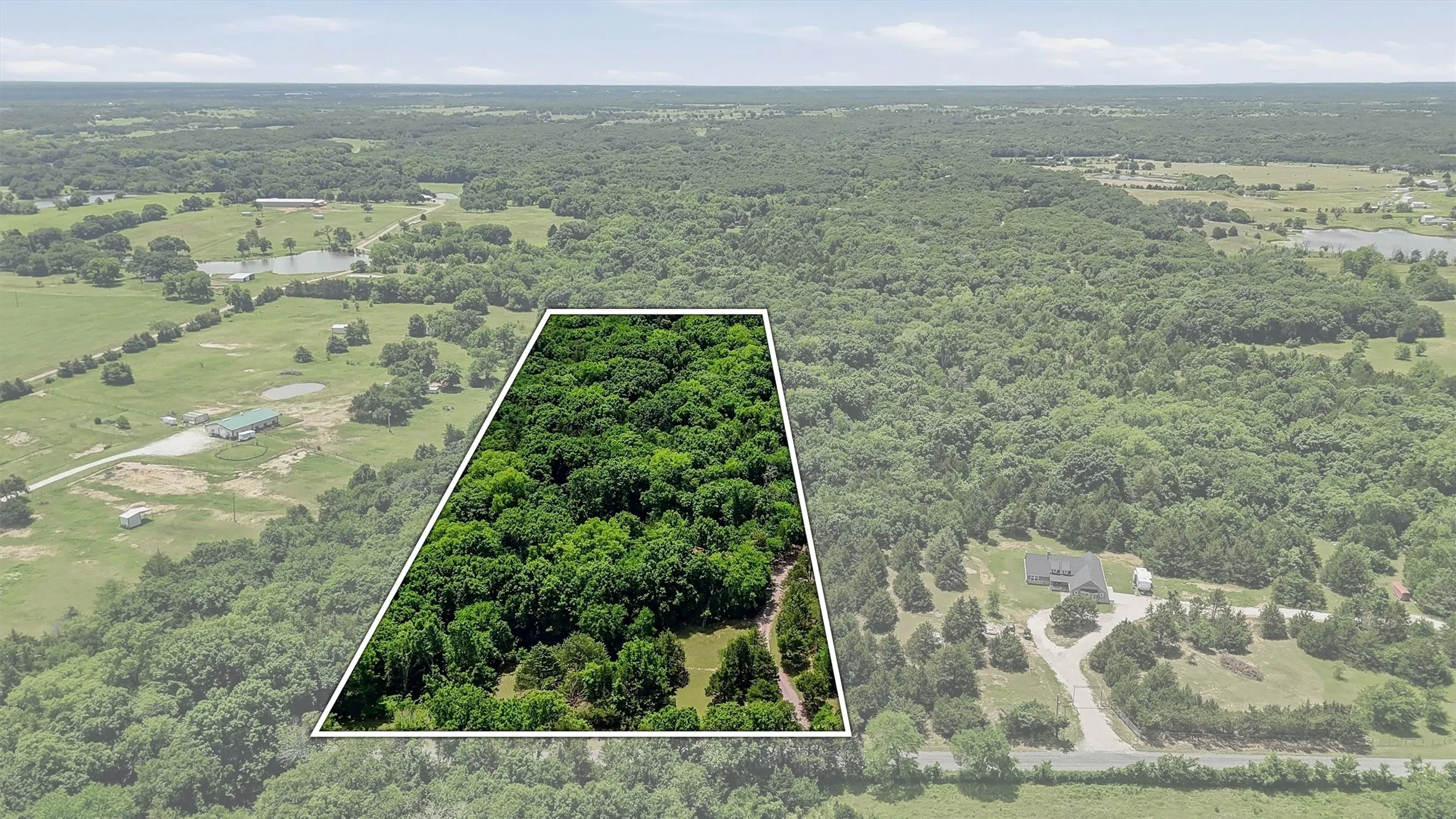 Expansive wooded acreage featuring mature trees and a clear perimeter outline