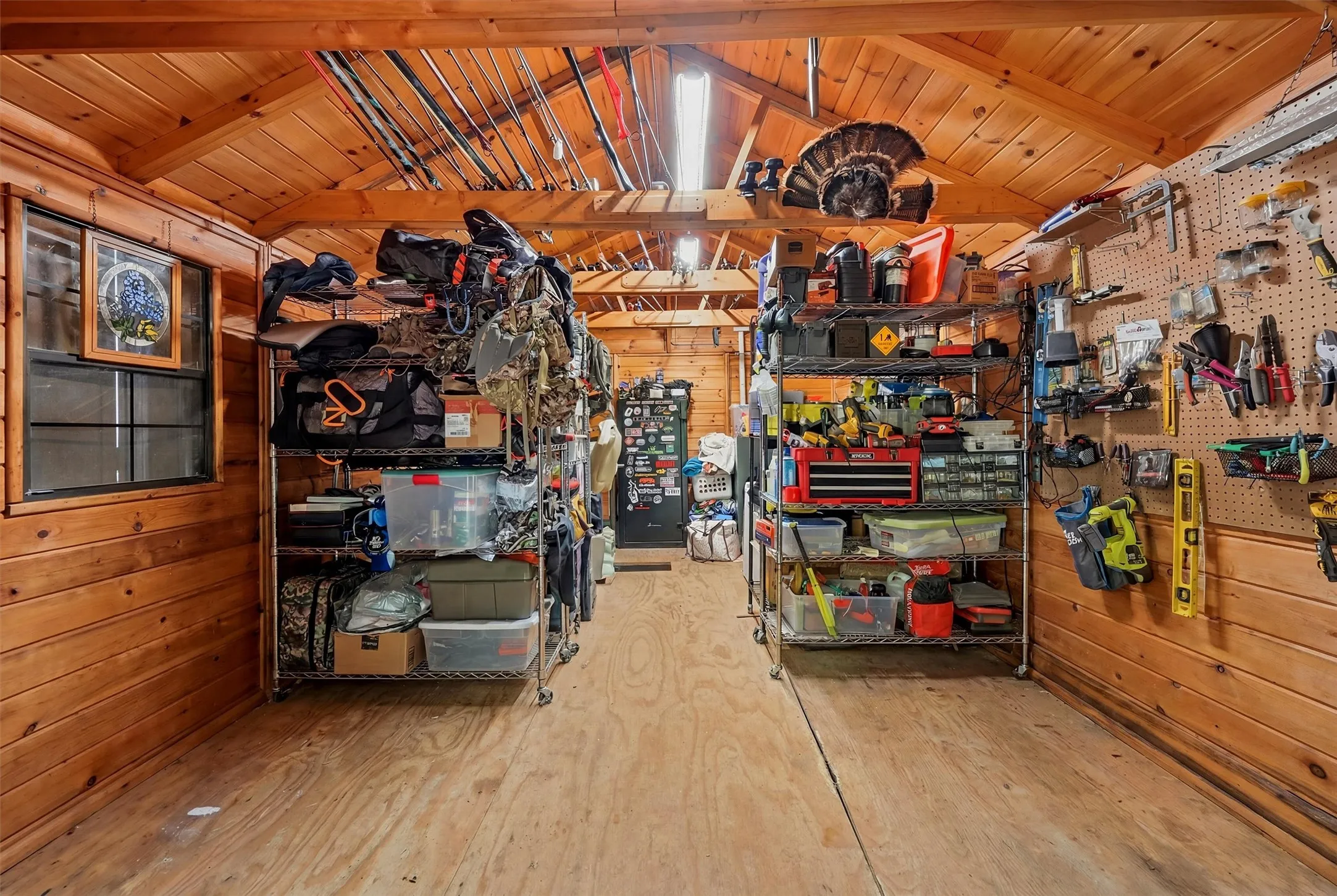 Utility shed interior featuring wood-finish walls and ceiling, a gabled roofline, and wood-finish flooring