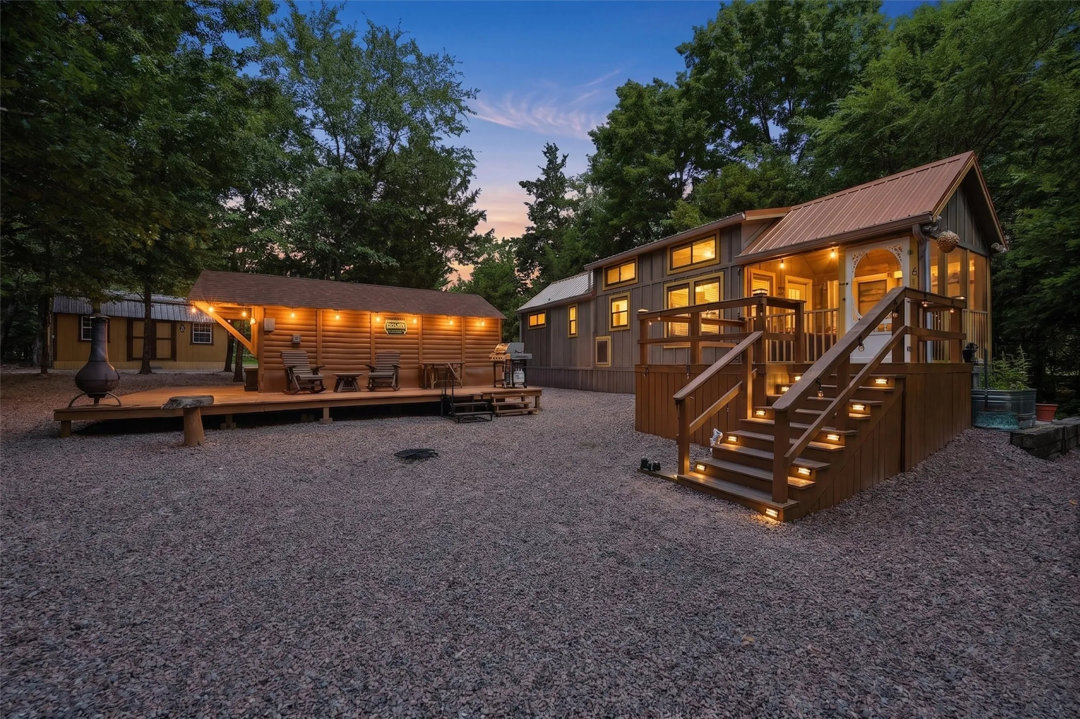 Rustic-inspired exterior featuring multiple wooden structures, a metal roof, and a gravel ground cover