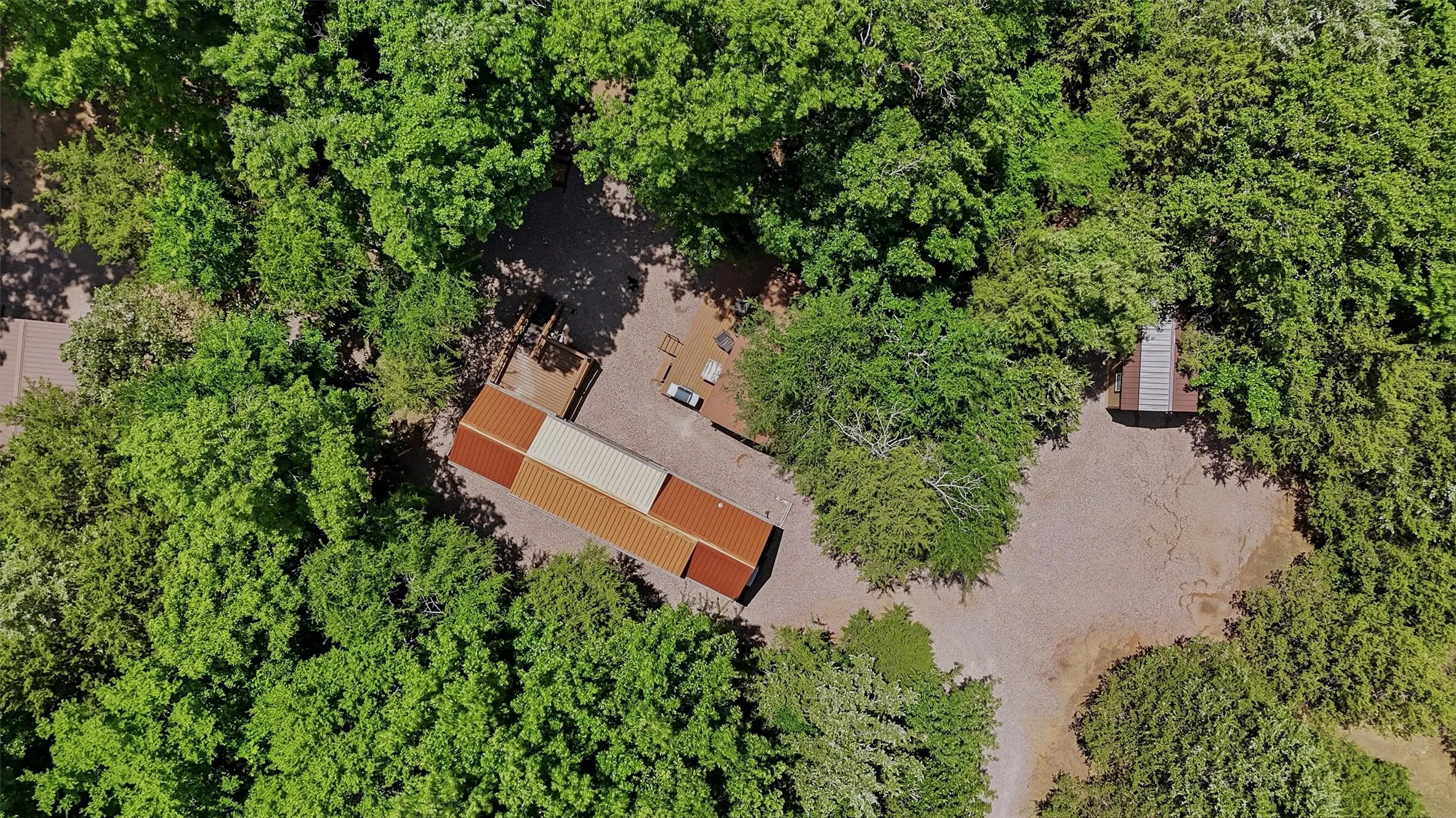 Aerial perspective showcasing a property surrounded by mature trees