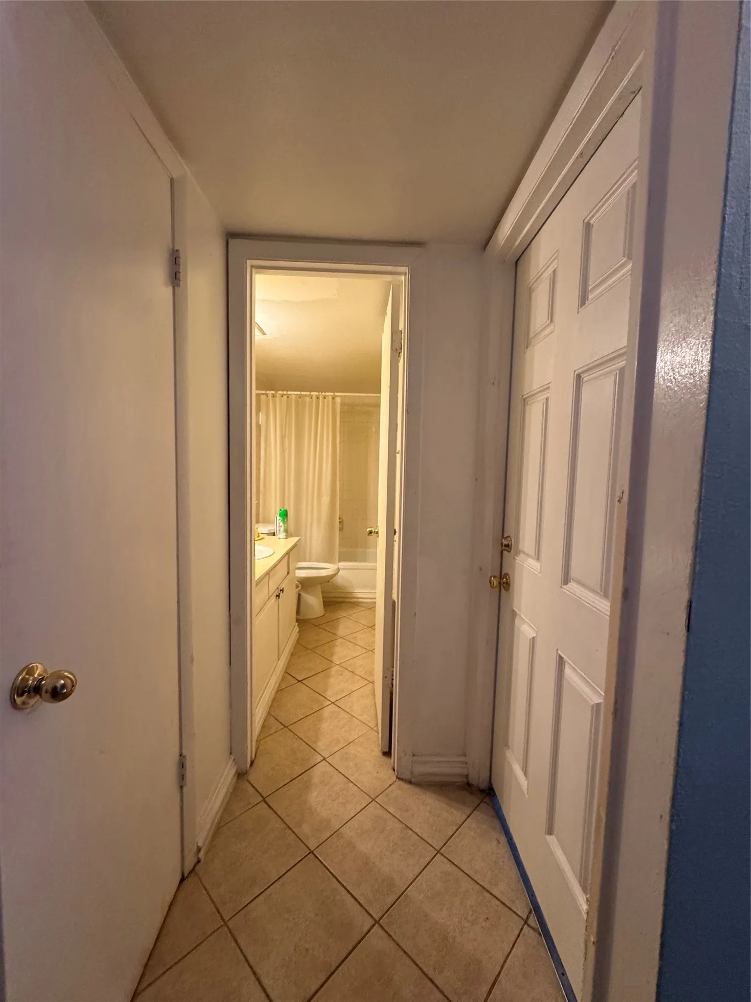 Hallway featuring diamond-patterned floor tiles