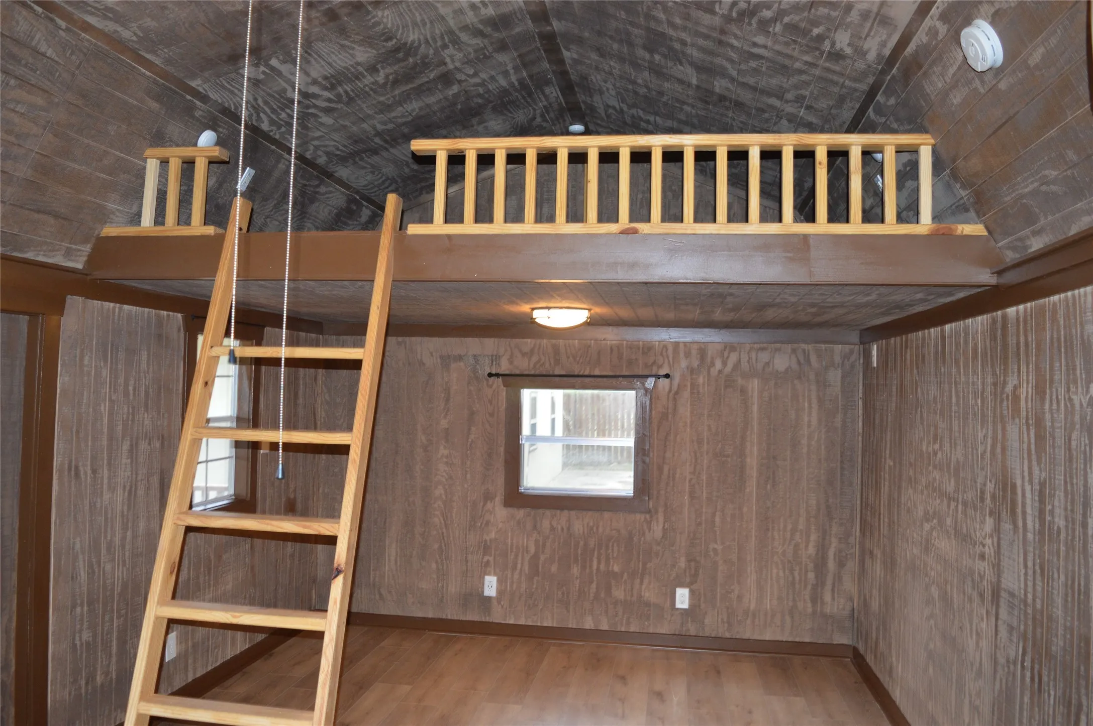 Interior space featuring wood-finish wall paneling and a wood-finish floor