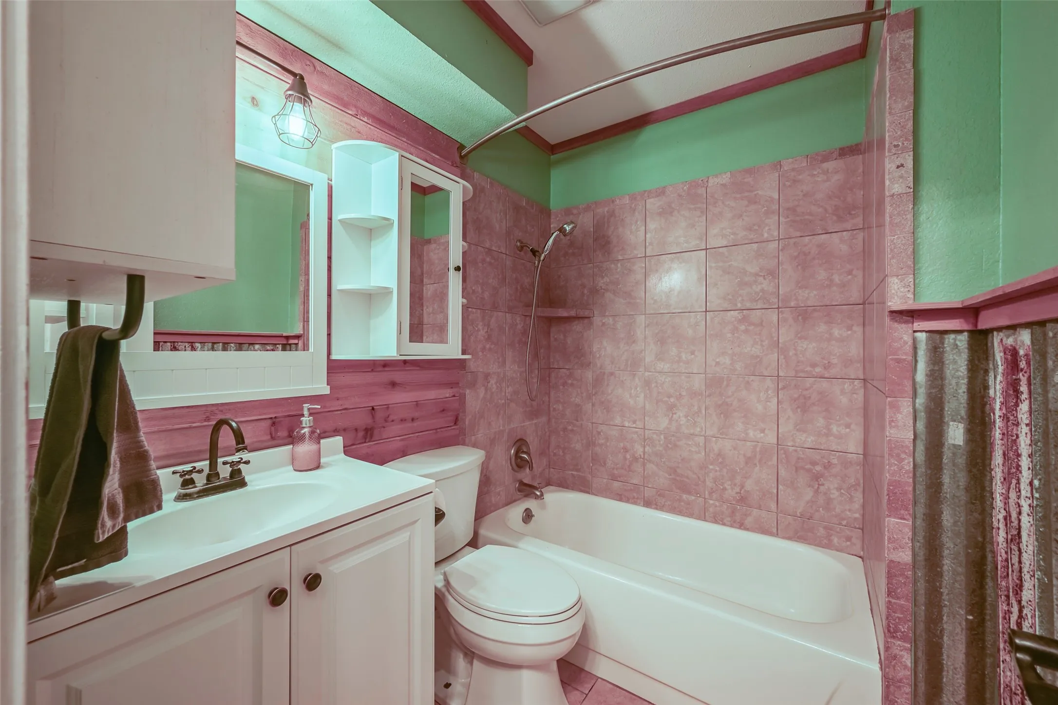 Bathroom featuring a white vanity with integrated sink, bronze-finish faucet, and coordinating bronze hardware