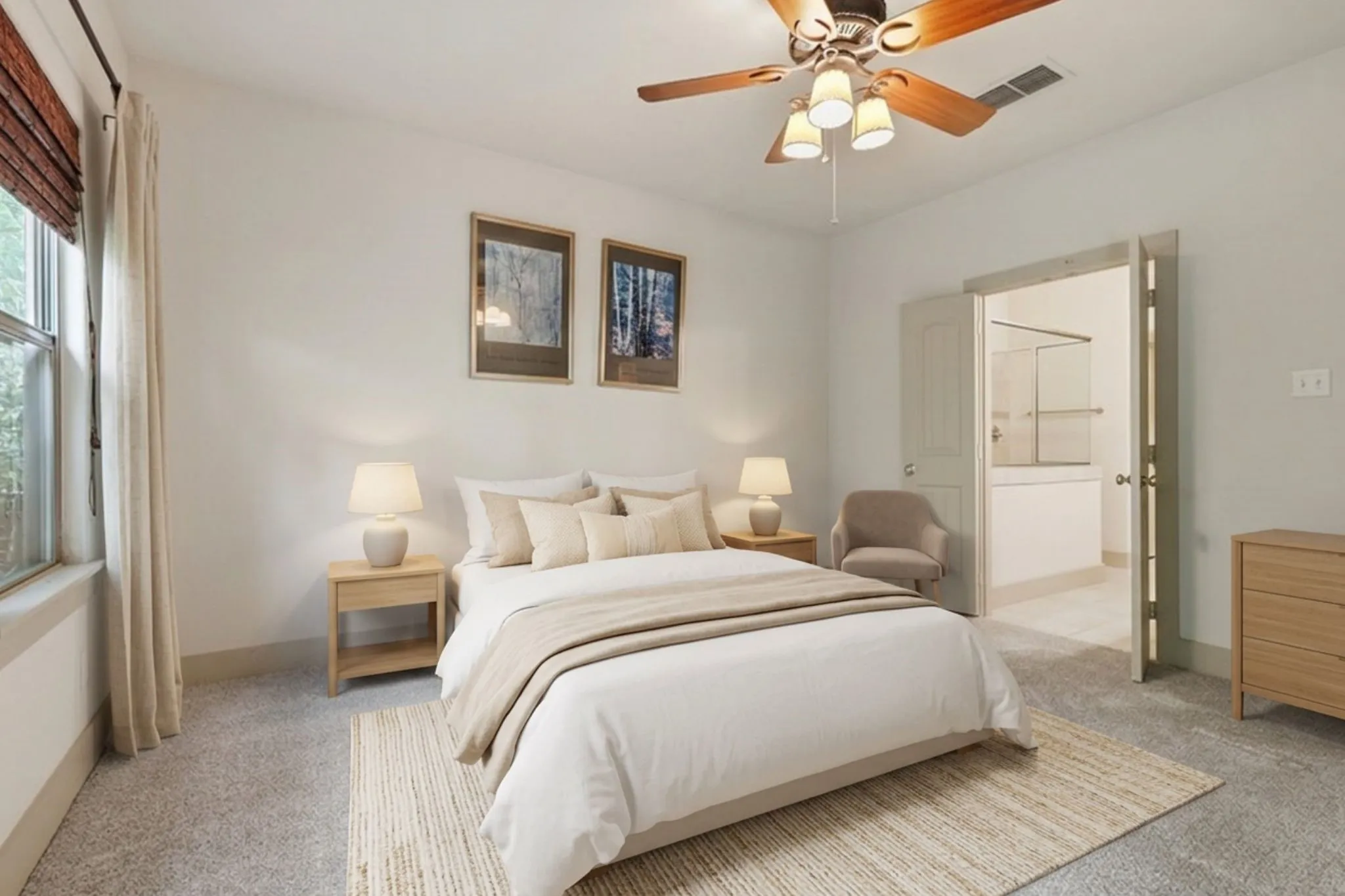 Serene primary bedroom showcasing neutral tones, dual nightstands with integrated lighting, a ceiling fan with fixture, and direct access to an ensuite bathroom