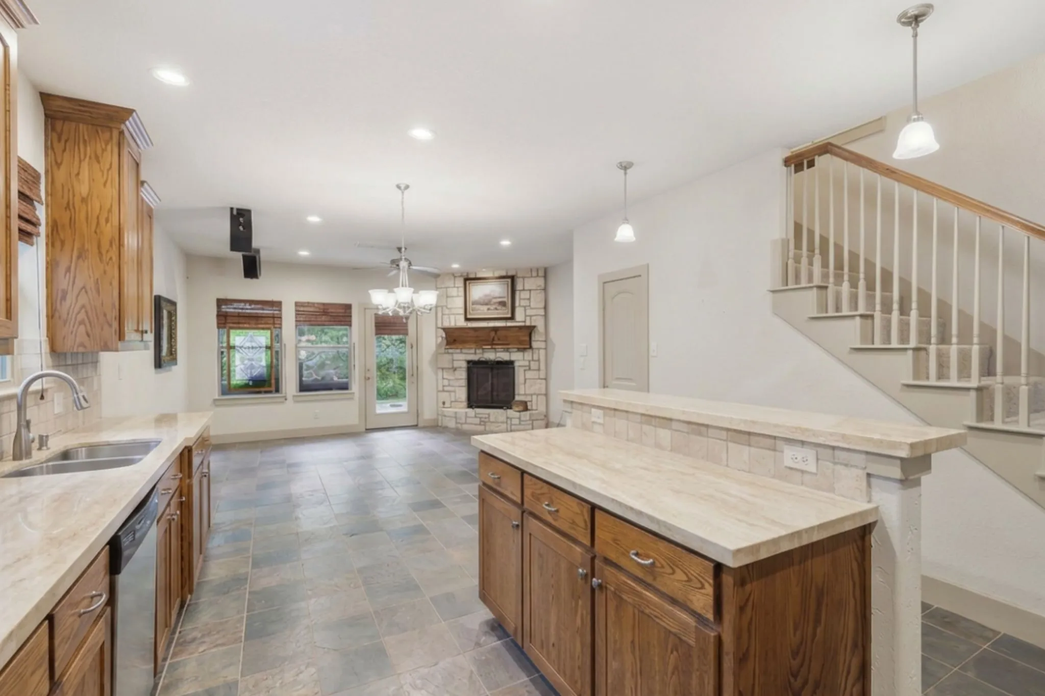 Kitchen with integrated stainless steel dishwasher, double basin sink, and wood cabinetry