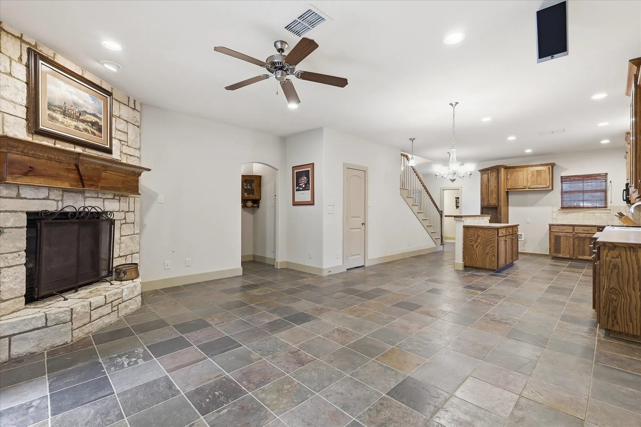 Spacious open-concept interior featuring varied-sized slate tile flooring throughout