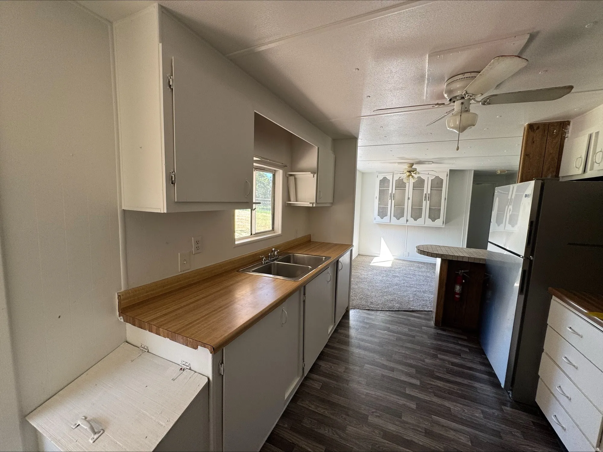 Kitchen with dining room in background.