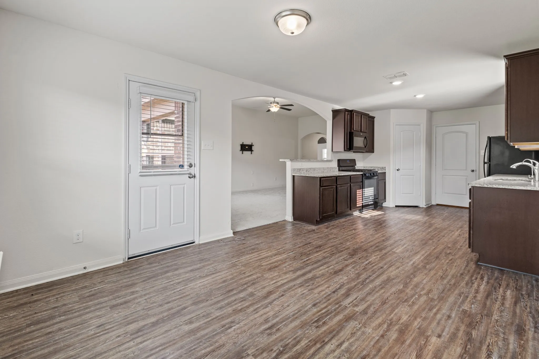 Open concept living space featuring wood-finish flooring