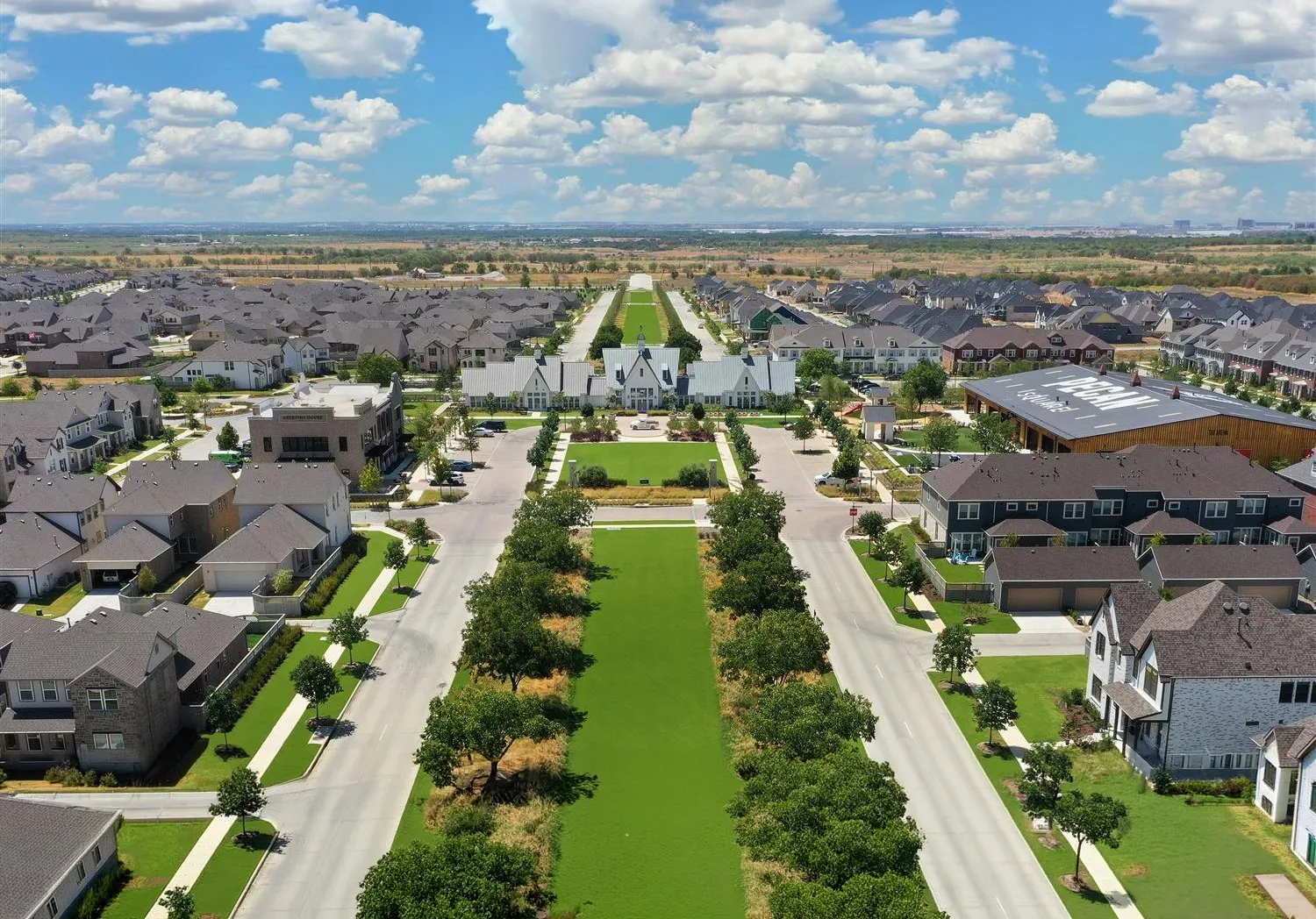 Aerial perspective of a planned community featuring a central green space