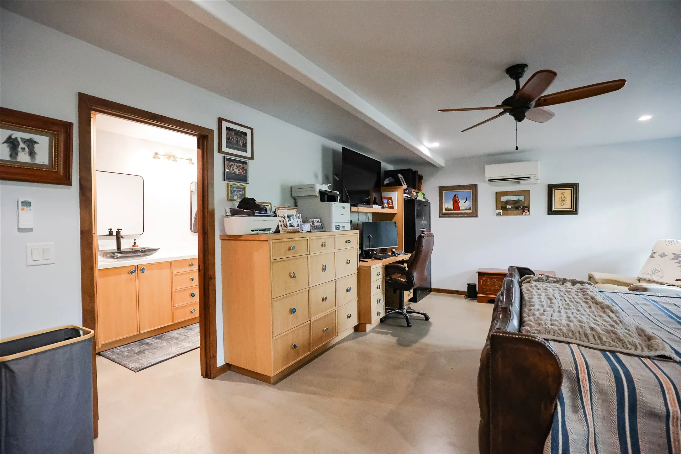 Spacious bedroom with double closets, knotty alder doors, a ceiling fan and room for a king bed. It's one of five bedrooms in this McCulloch County ranch house.