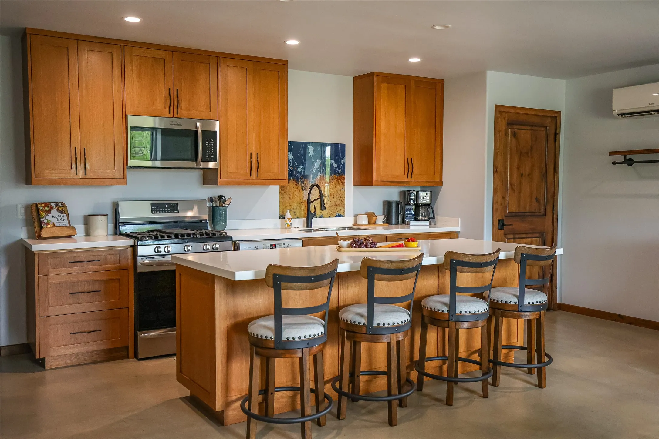 accessible living and dining area on the main floor, with wide open circulation space, sealed concrete floors and natural light. It's a private suite inside the barndominium, well suited for long term guests or extended stays.