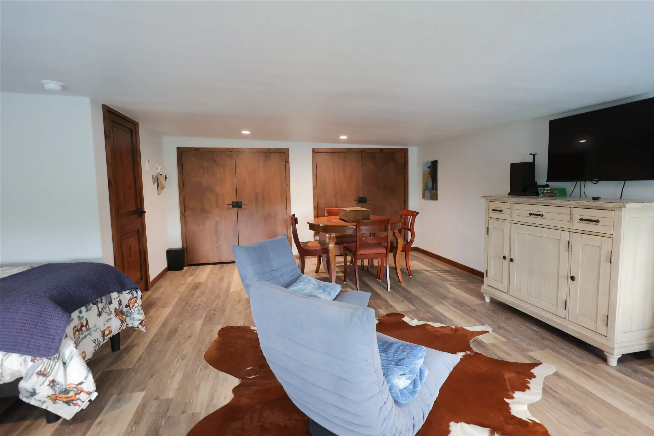 The same oversized bunk room has a sitting area, a game table, a TV wall and two sets of double closets with knotty alder doors. There's room to relax, play cards or plan the next morning's hunt.