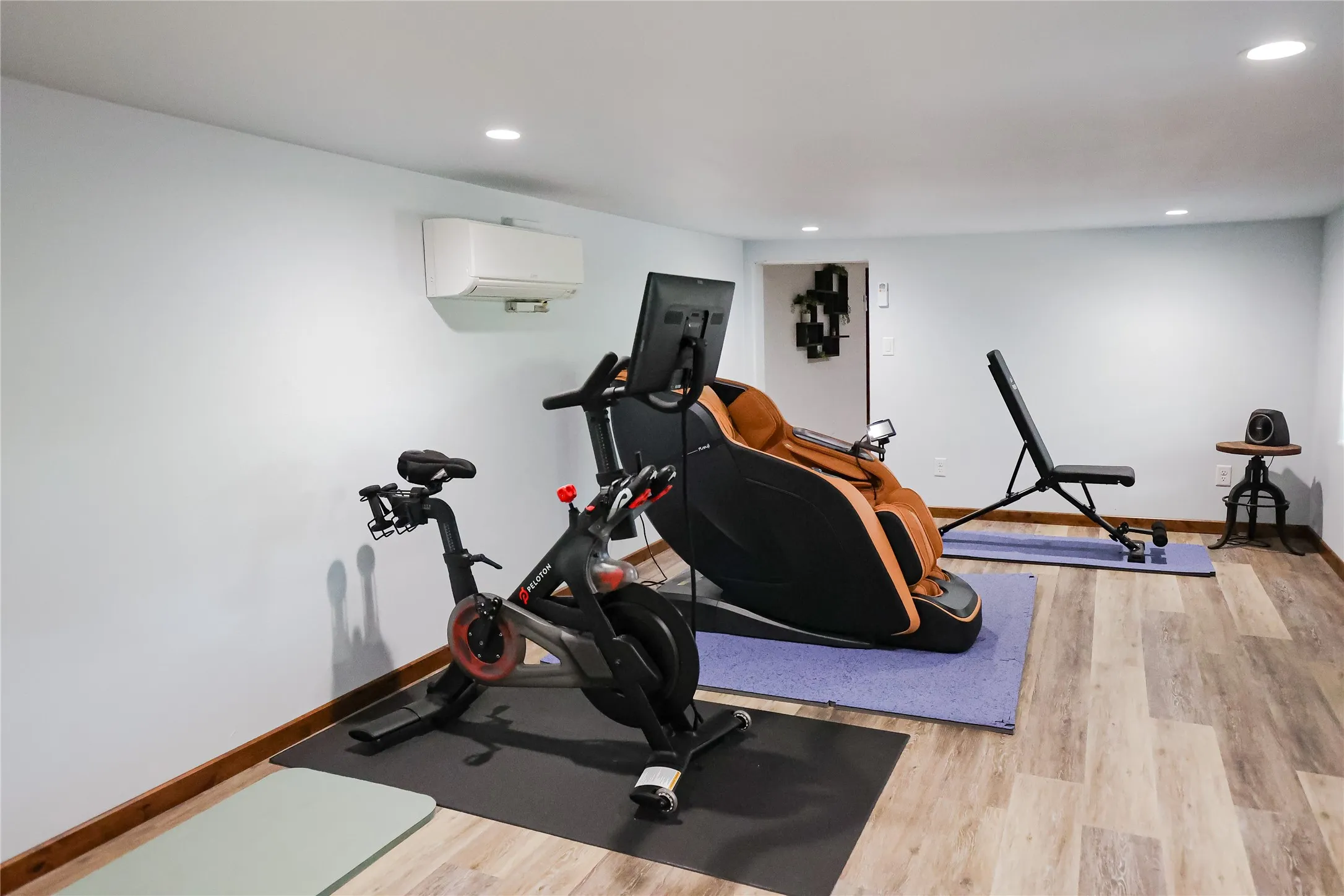 Private exercise room with luxury vinyl plank floors, recessed lighting and its own mini split. There's room for cardio, weights and recovery after a day of ranch work or hunting.
