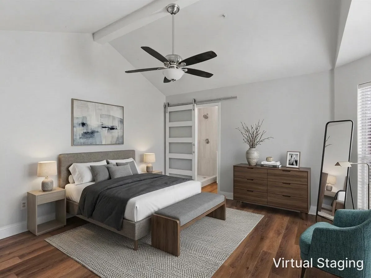 Vaulted ceiling with exposed beam, ceiling fan with light fixture, wood-finish flooring, sliding barn door, and window with blinds
