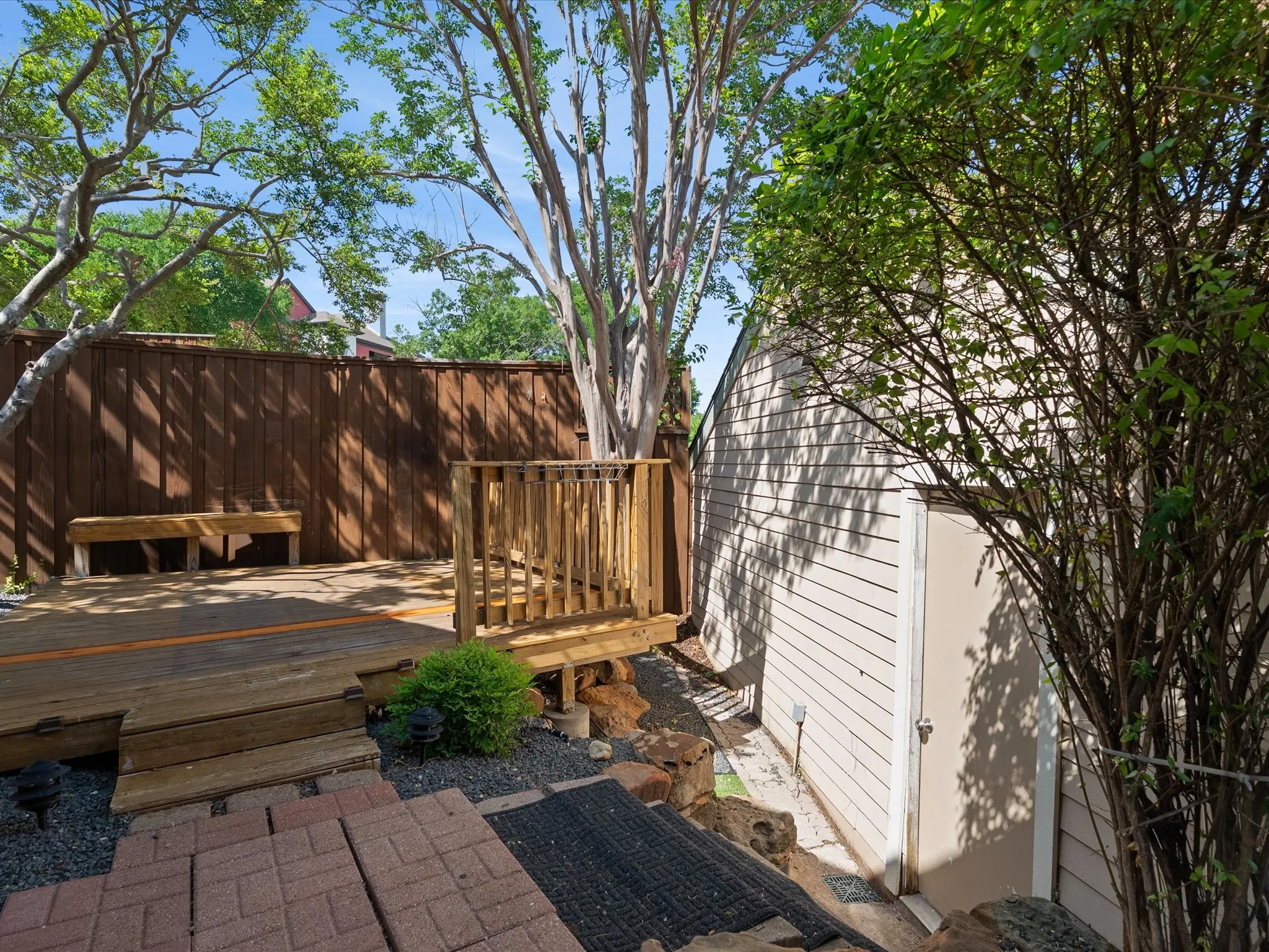 Wood deck featuring a built-in bench, wood railing, and privacy fence